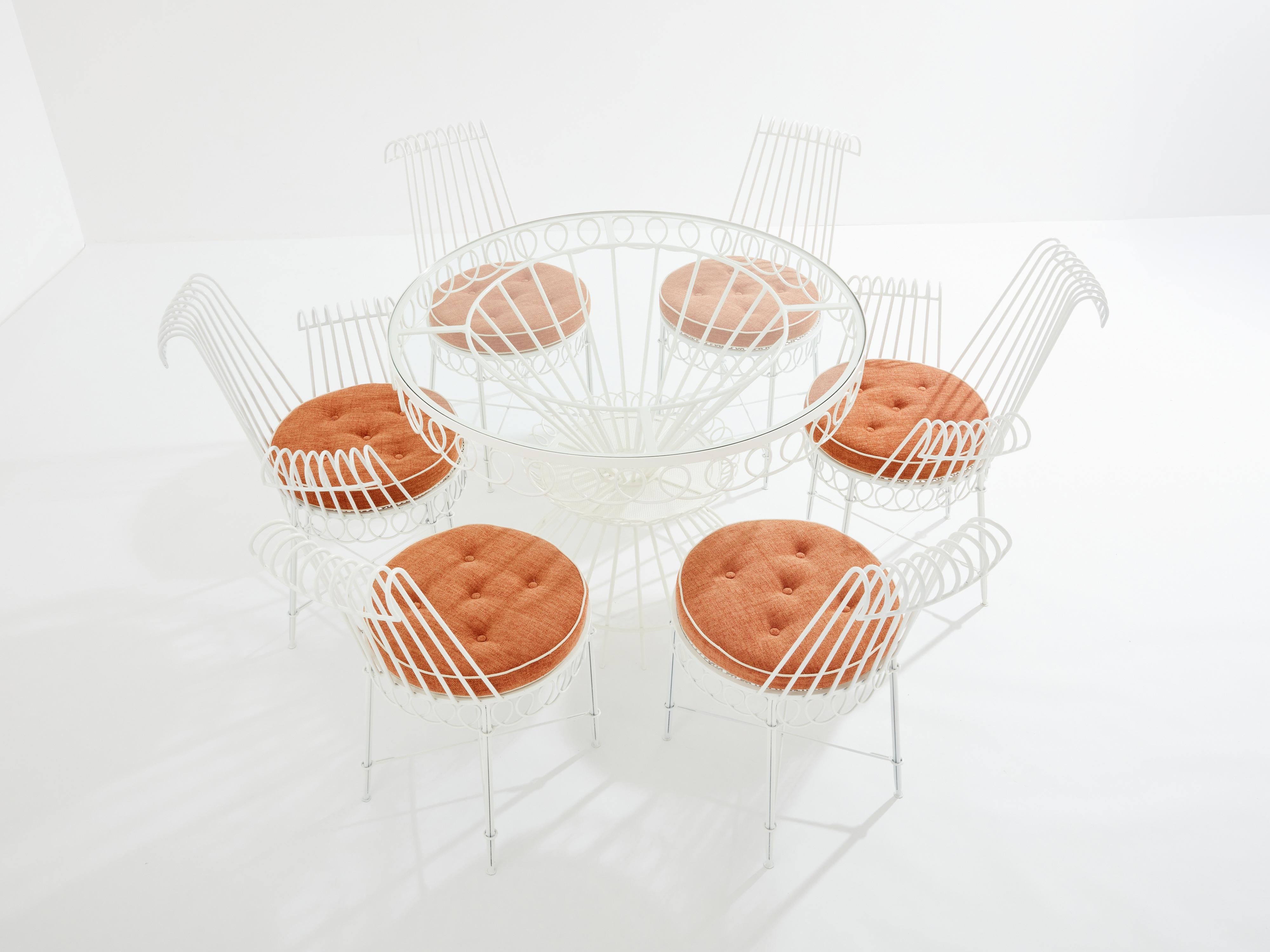 This iconic dining set is an original creation by Mathieu Matégot, dating back to the 1950s. The table, along with the two armchairs and four chairs, is crafted from white lacquered metal. The meticulous handling of the raw material showcases the