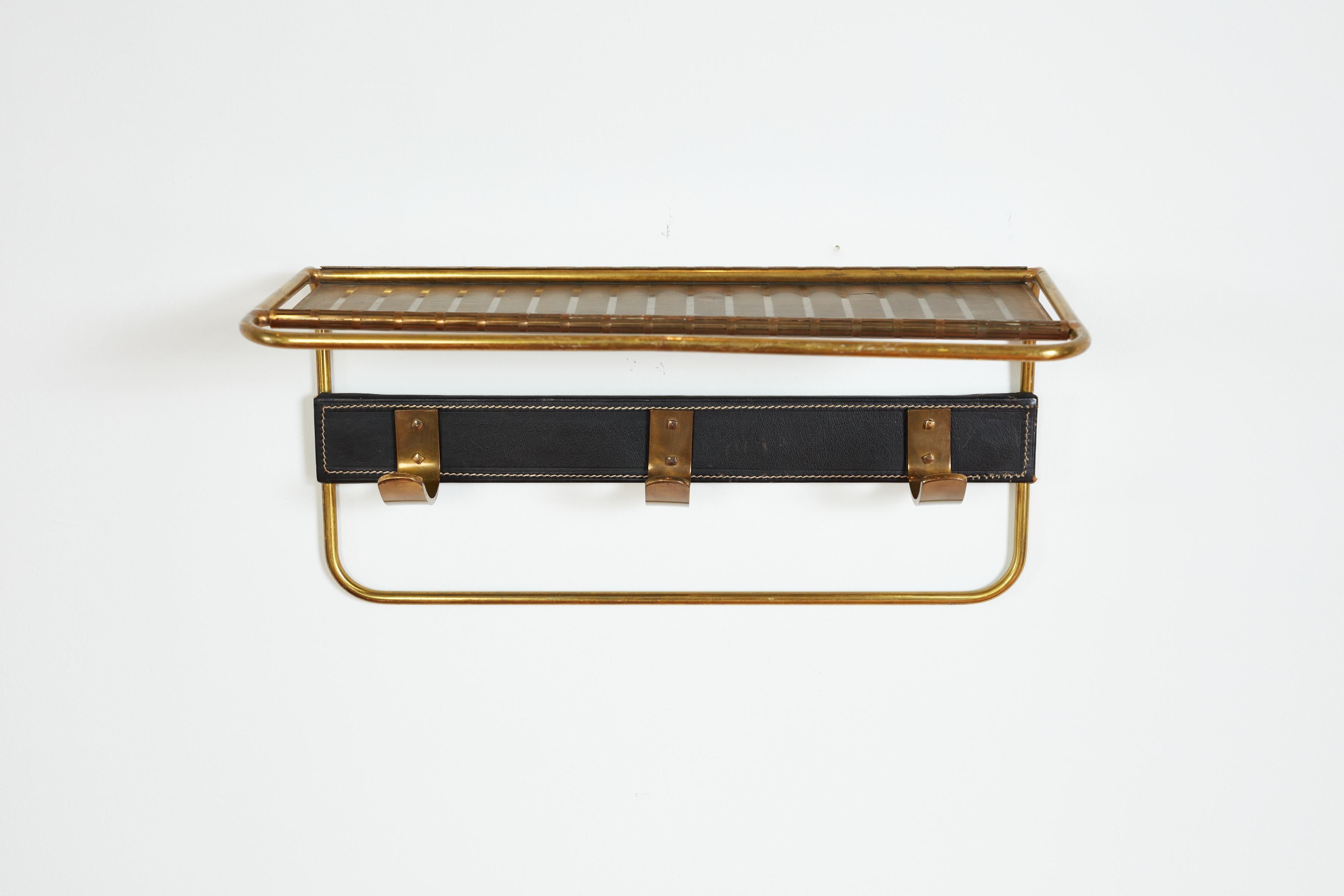 Handsome coatrack by Mathieu Mategot - France, 1950s
Leather with contrast stitching and perforated brass shelf, brass hooks. 
Wonderful patina.