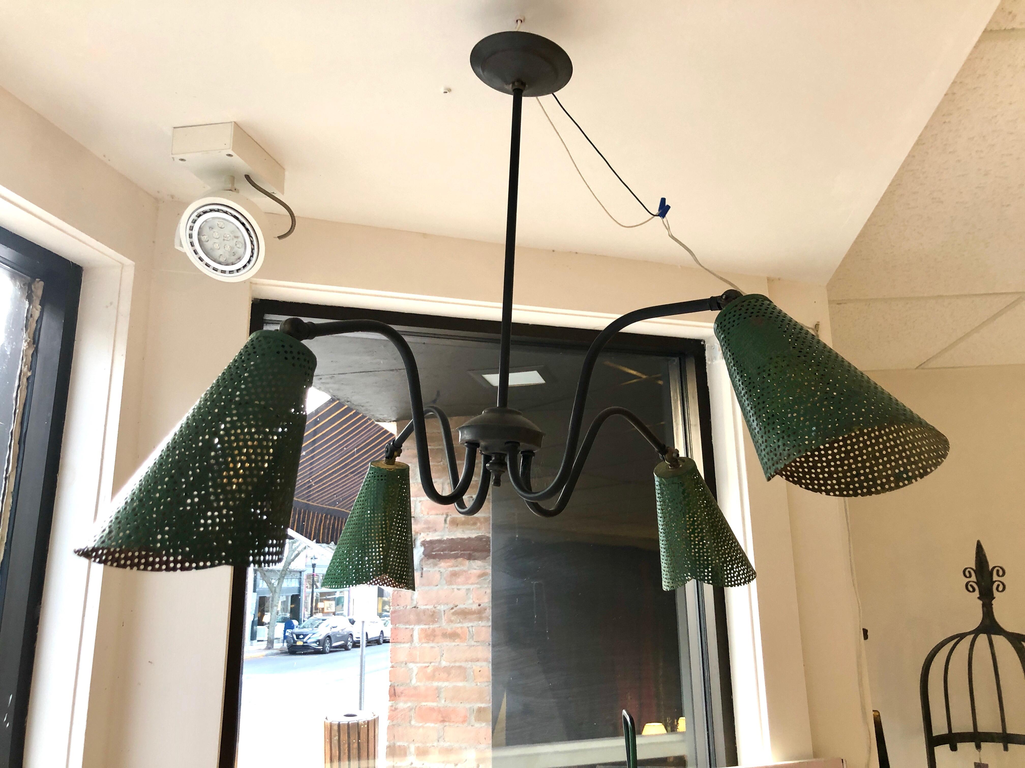 French modernist ceiling lamp makes great design out of common industrial materials. Four fully pivoting sheet metal shades provide great direct and ambient light.