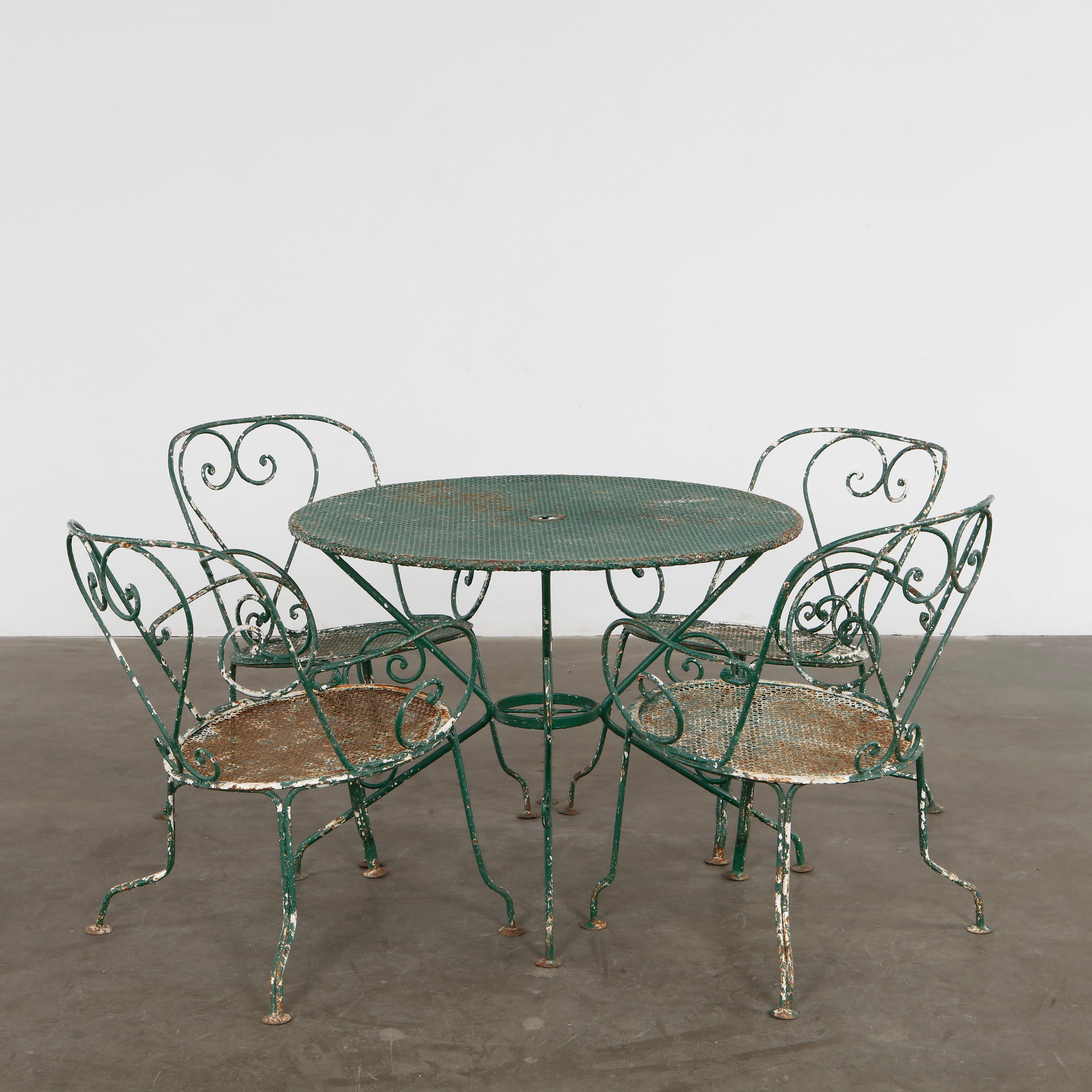 Five-piece set in green metal mesh. Mategot joyful utility meets garden elegance. Chairs: Height: 28.6 in. Width: 22.5 in. Depth: 23 in. Seat Depth: 19.5 in. Seat Height: 15.5 in. Table: Height: 27 in. Diameter: 37 in.