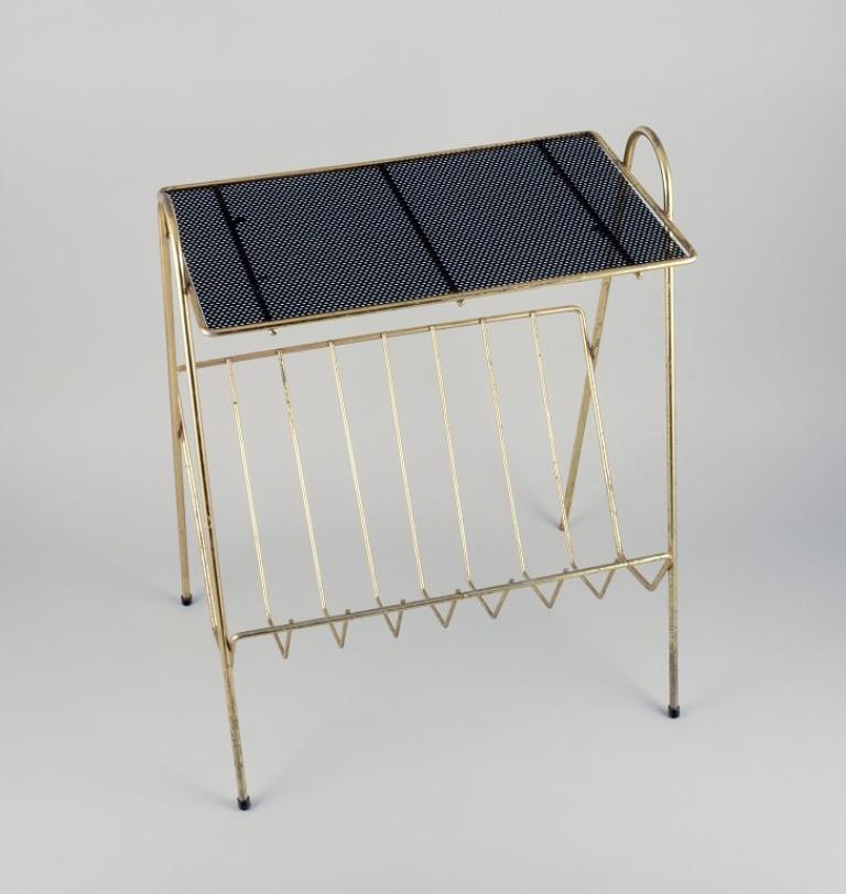 Mathieu Matégot (1910 - 2001), Hungarian-French industrial designer. 
Magazine holder in brass with black metal mesh.
Approximately from the 1960s.
In excellent condition with a lovely patina.
Dimensions: Height 53.5 cm x Width 42.0 cm x Depth 30.5