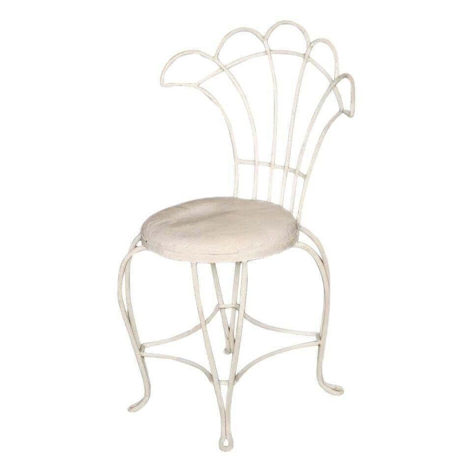 Reminiscent of a Paris cafe, a set of four French wrought iron outdoor/patio chairs with distinct floral inspired fan backrest. This chair is constructed with solid core wrought iron professionally refinished in a pure white Rustoleum finish and a