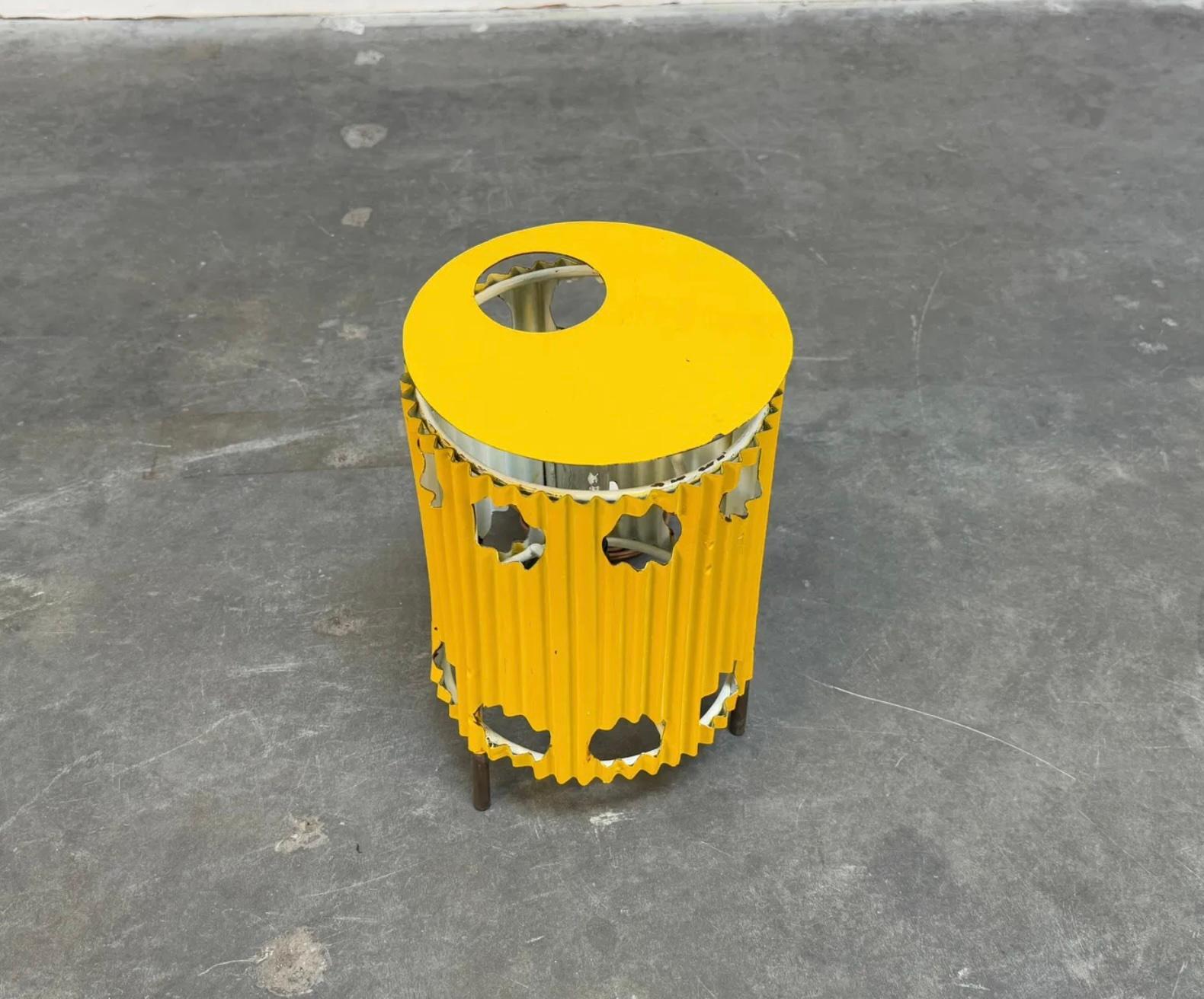 A rare yellow Java lamp designed by Mathieu Mategot in 1954. Featuring his signature perforated metal shade and delicate, curved design.