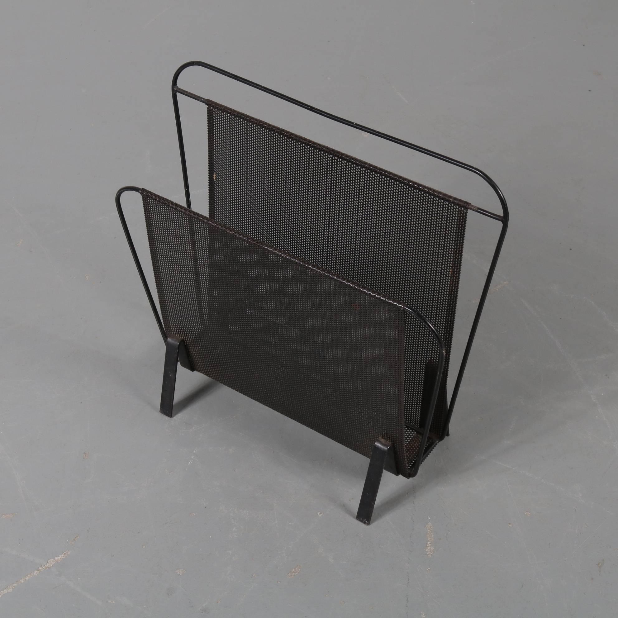 A beautiful elegant magazine rack, model Harpers, designed by Mathieu Matégot and manufactured by Artimeta in the Netherlands, circa 1950.

This iconic piece is made of high quality black lacquered metal. The structure is folded and the metal
