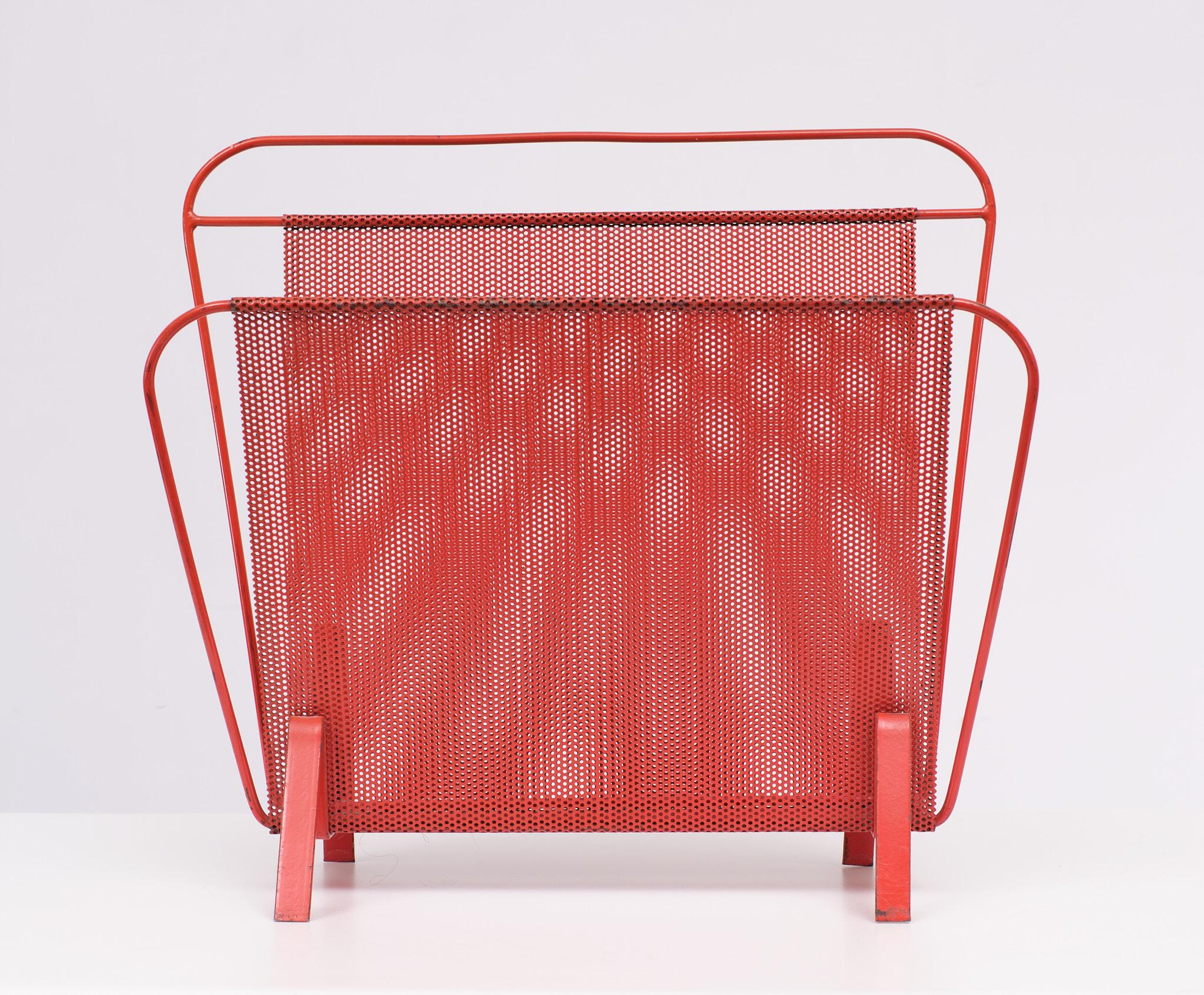 Vintage design magazine holder of perforated metal. Nice bright Red color The magazine holder is designed by Mathieu Mategot for Artimeta, Soest in the early sixties. The condition is good, see the detail photos.