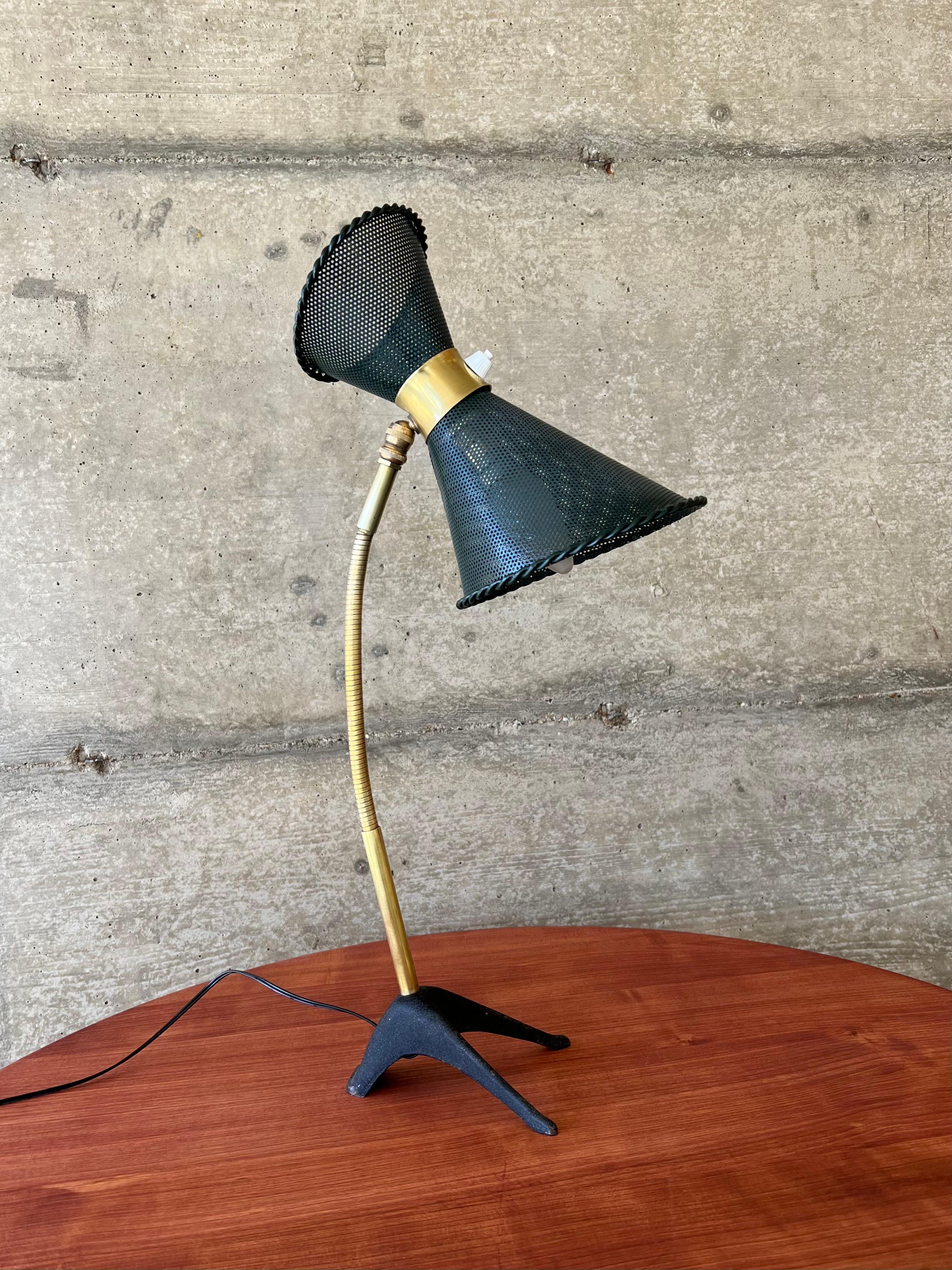 Very rare French table lamp designed by Mathieu Matégot, executed by Atelier-Matégot. A beautiful lampshade in the shape of a diabolo, perforated metal which made Matégot famous. The lamp is in its original condition and color, only the lampshade