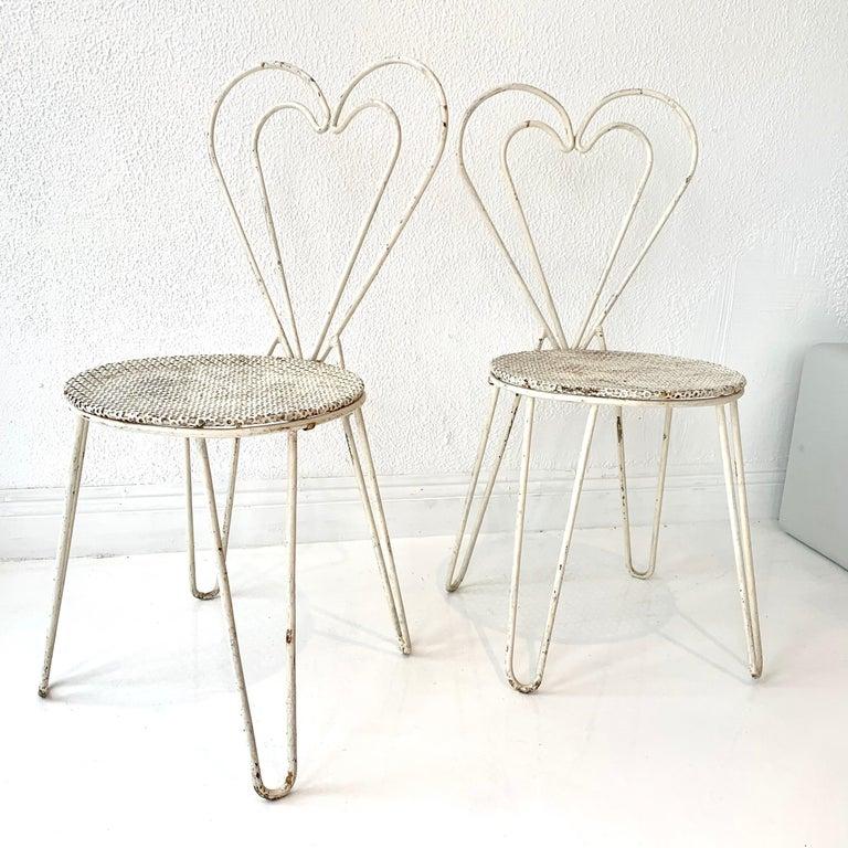Rare metal chairs by French designer Mathieu Matégot. White metal chairs with hairpin legs, signature Mategot perforated metal seat and heart shaped backrest. Great vintage condition. Priced individually. 6 available.






