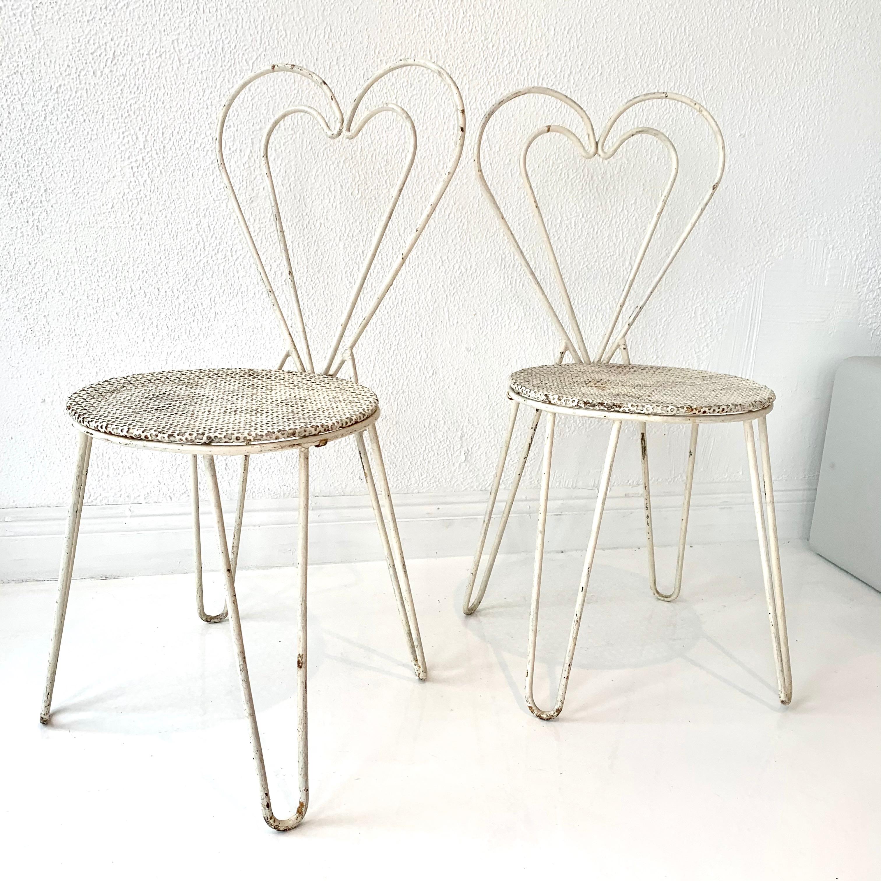 Rare metal chairs by French designer Mathieu Matégot. White metal chairs with hairpin legs, signature Mategot perforated metal seat and heart shaped backrest. Priced as a set of 6. Great vintage condition. 






  