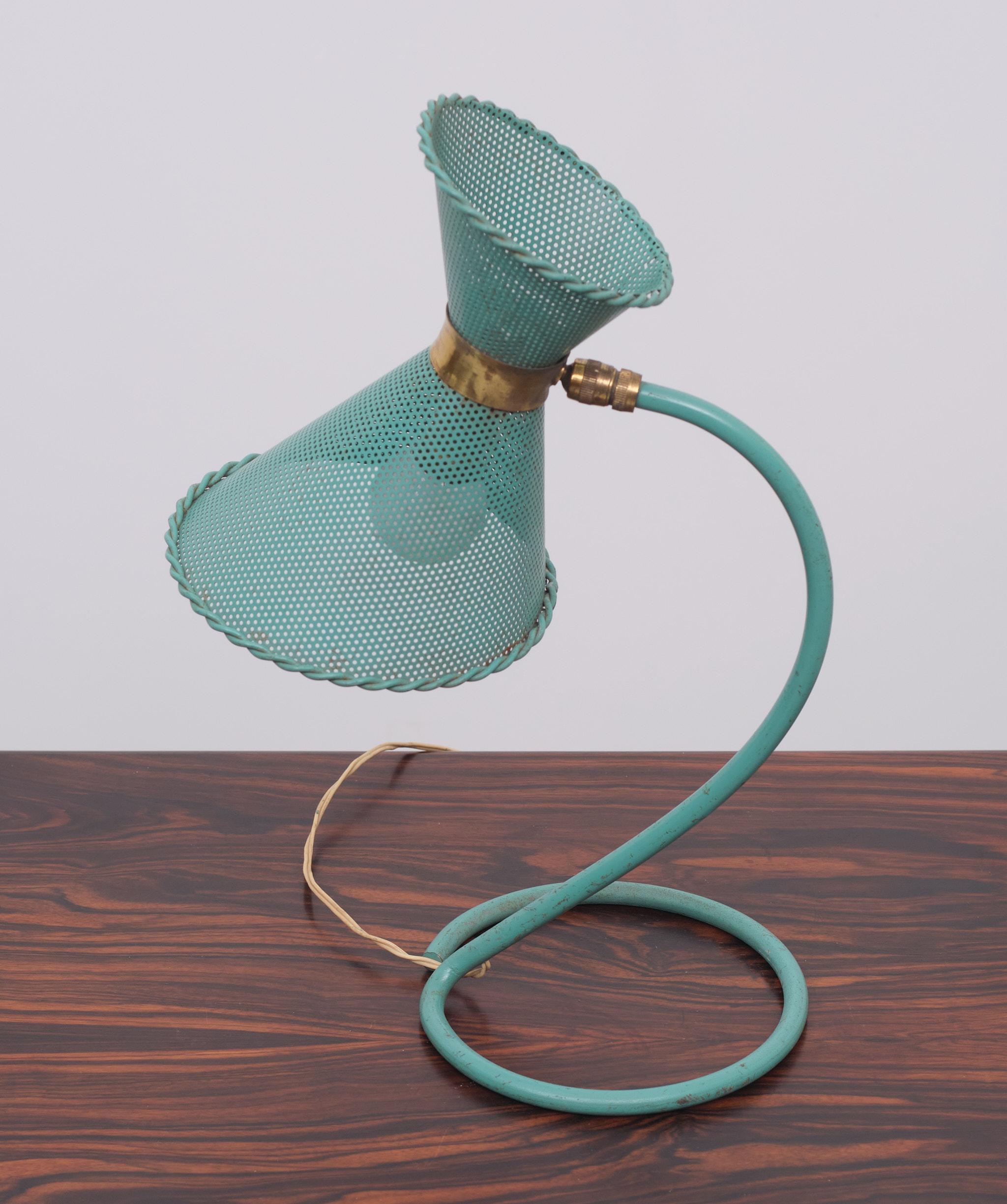 Rare, French table lamp designed by Mathieu Matégot and executed by Atelier-Matégot. A beautiful shade in the form of a diabolo, perforated metal where Matégot was so famous for. The lamp is in its original condition, and color which means there are