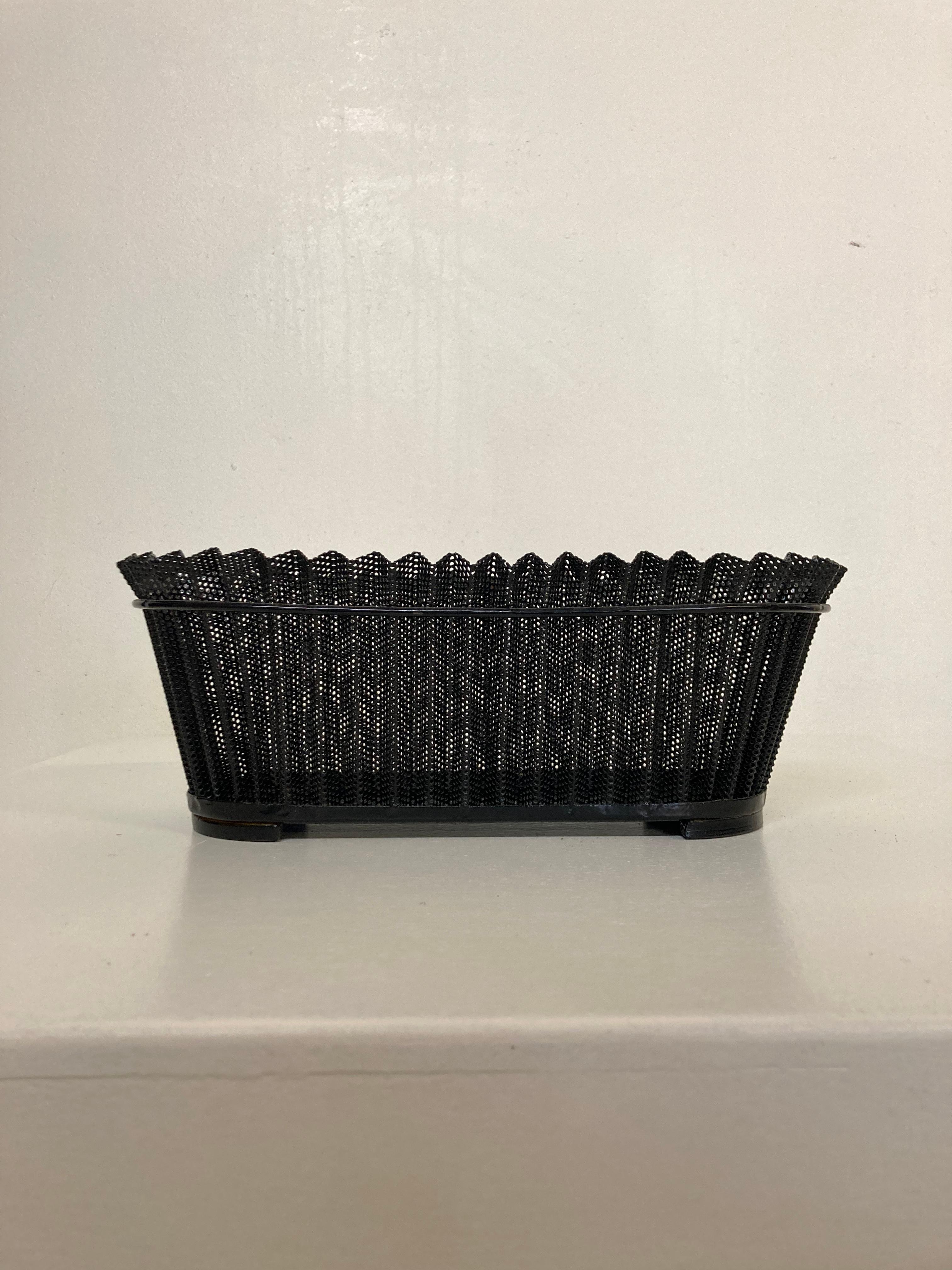 Midcentury modern planter by French designer Mathieu Matégot. 
Black lacquered perforated folded metal (Rigitulle). 

Literature: 