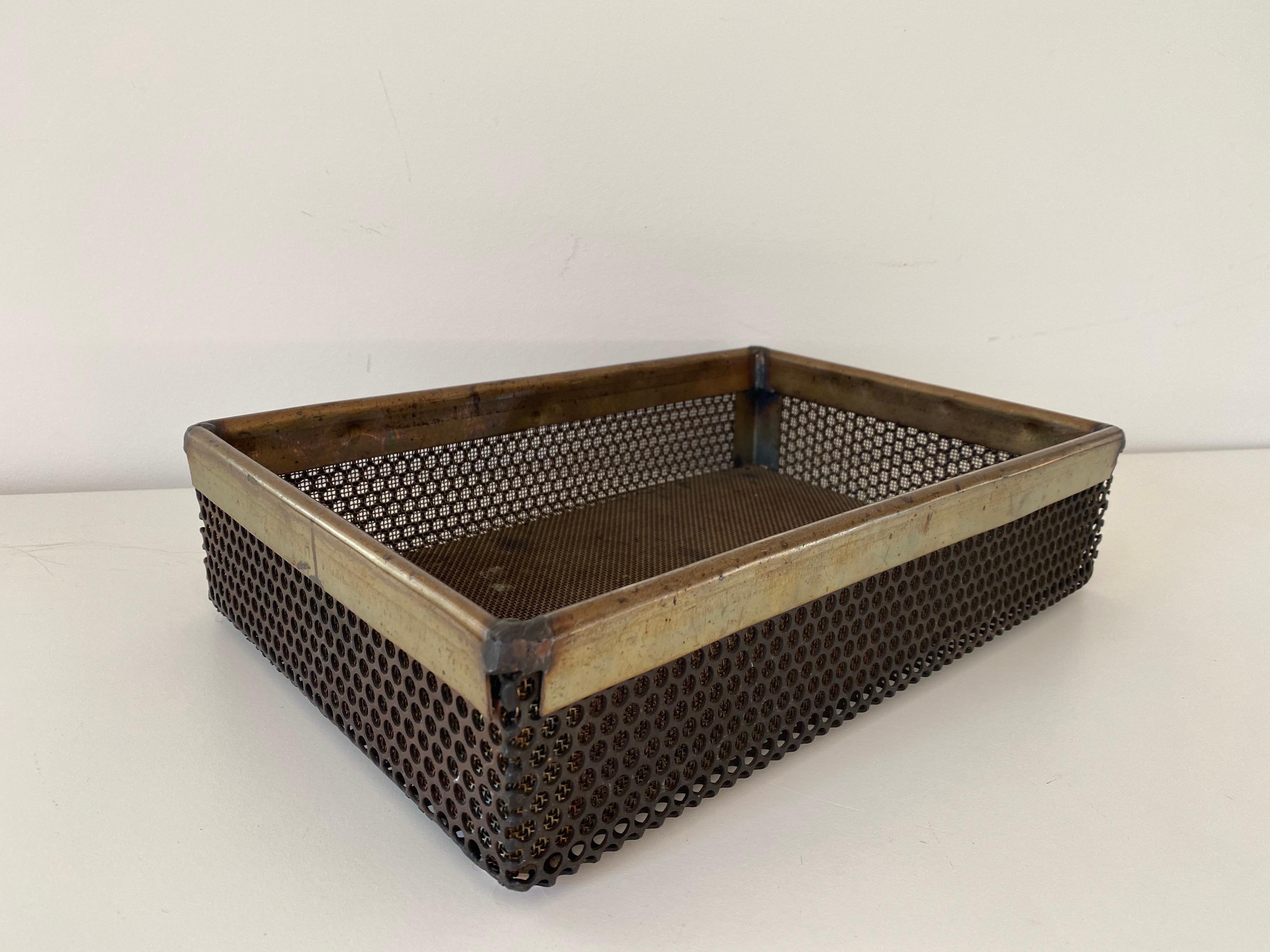 A Mathieu Matégot metal perforated tray. This rare example includes thick brass banding.