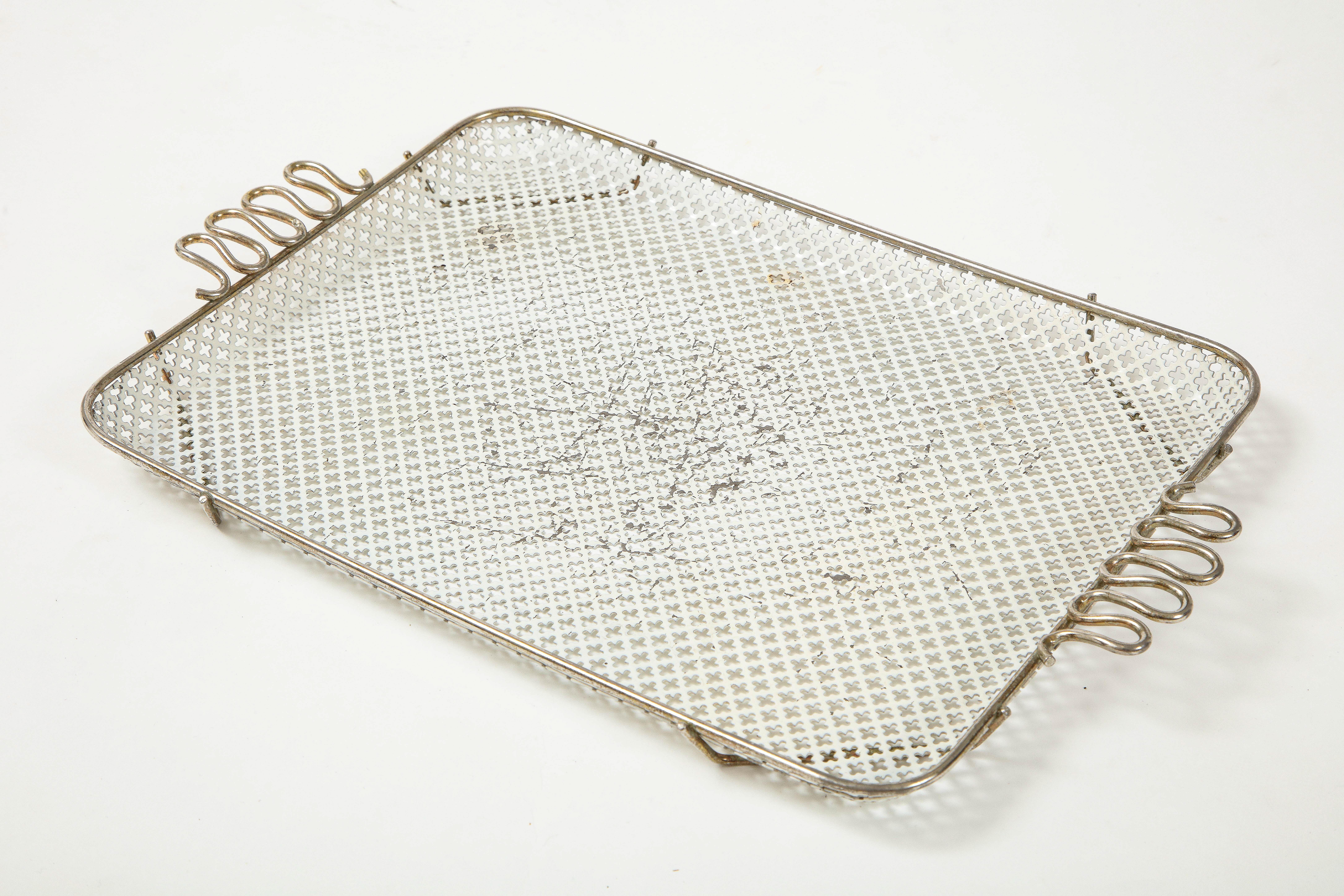 French Modernist perforated tray with metal banding around perimeter and sinuous handles. Worn center. We will leave it to you to decide whether to repaint.
