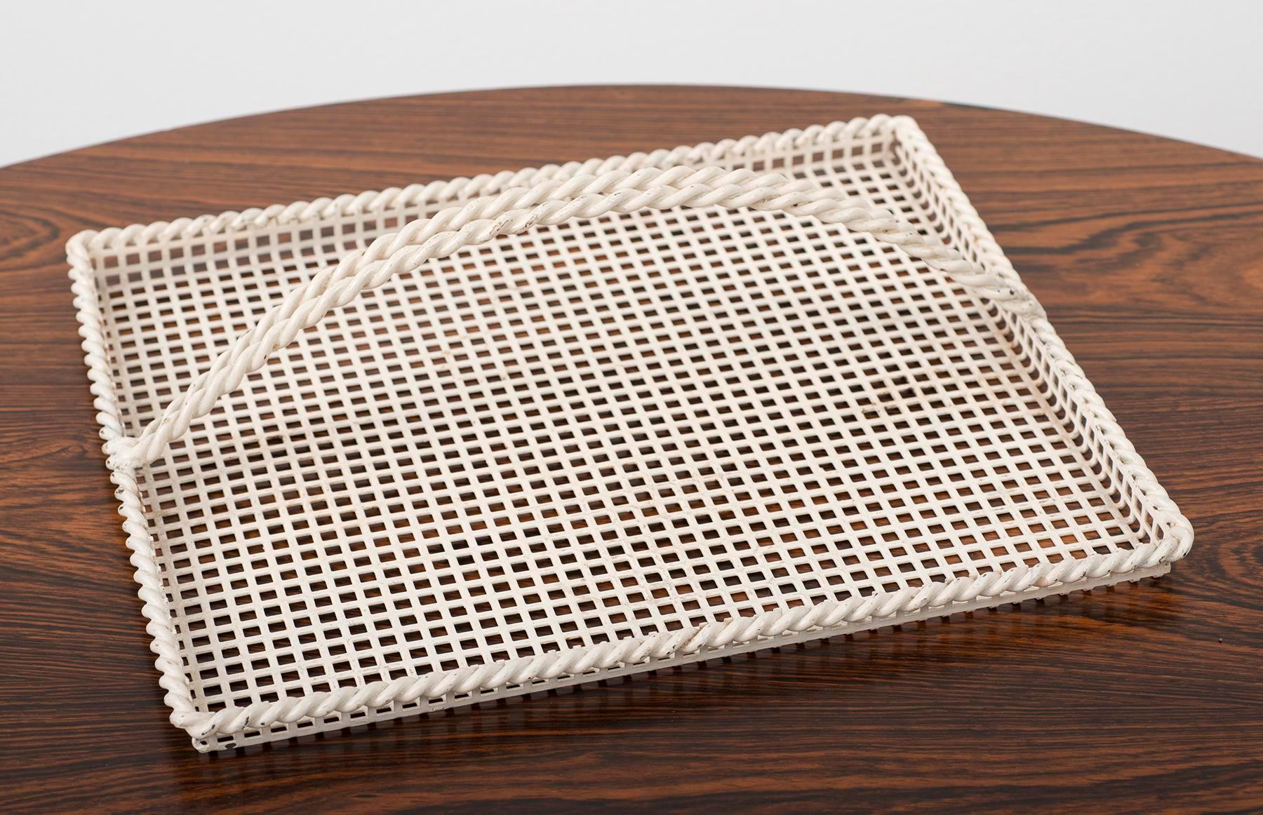 Elegant example of French 1950s metalwork by Mathieu Matégot. Off-white enamel finish in excellent vintage condition. Perforated metal in square grid pattern with twisted border and handle.