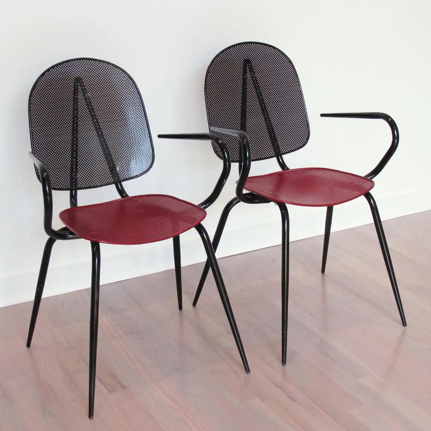 These stunning metal chairs or armchairs have a design reminiscent of Mathieu Mategot's work. They feature a striking example of French 1950s metalwork, with folded and perforated black and red lacquered metal. This superb modernist shape is very