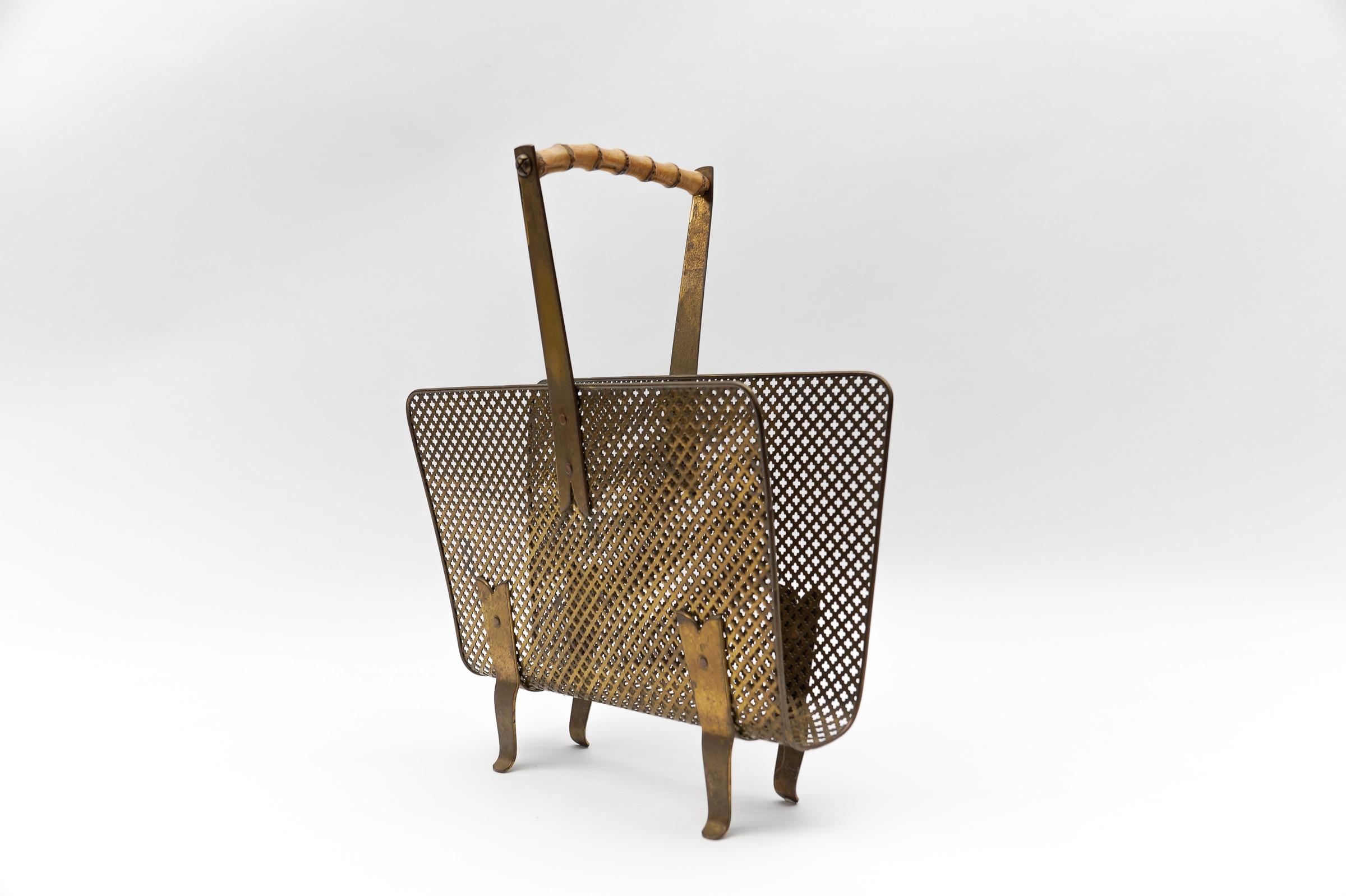 Very shapely newspaper holder in the style of Mategot. Perforated metal and brass. 