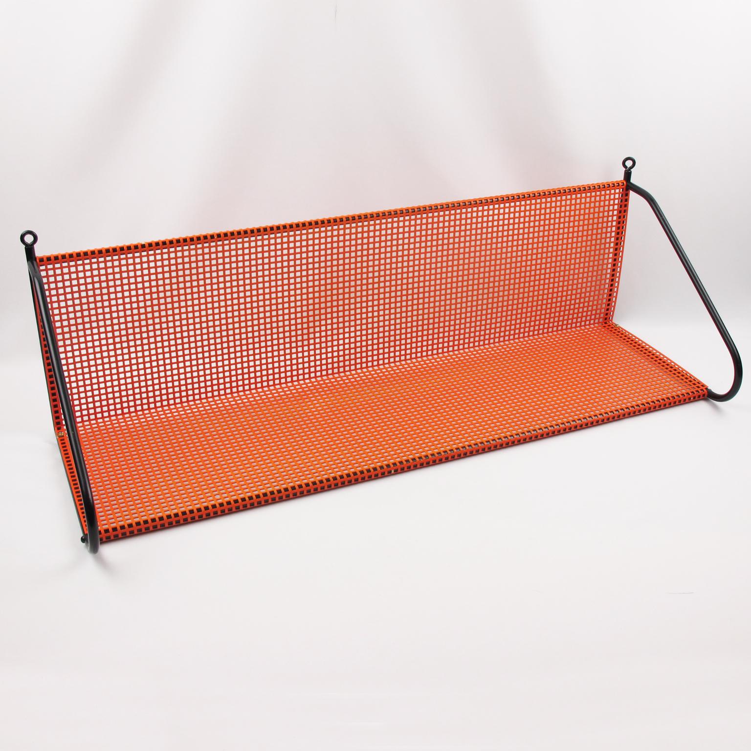 Unusual second half of the 20th century modernist metal shelving unit in the manner of French designer Mathieu Matégot. A striking example of French 1950s metalwork. Folded, perforated orange lacquered metal with black metal support.
Measurements: