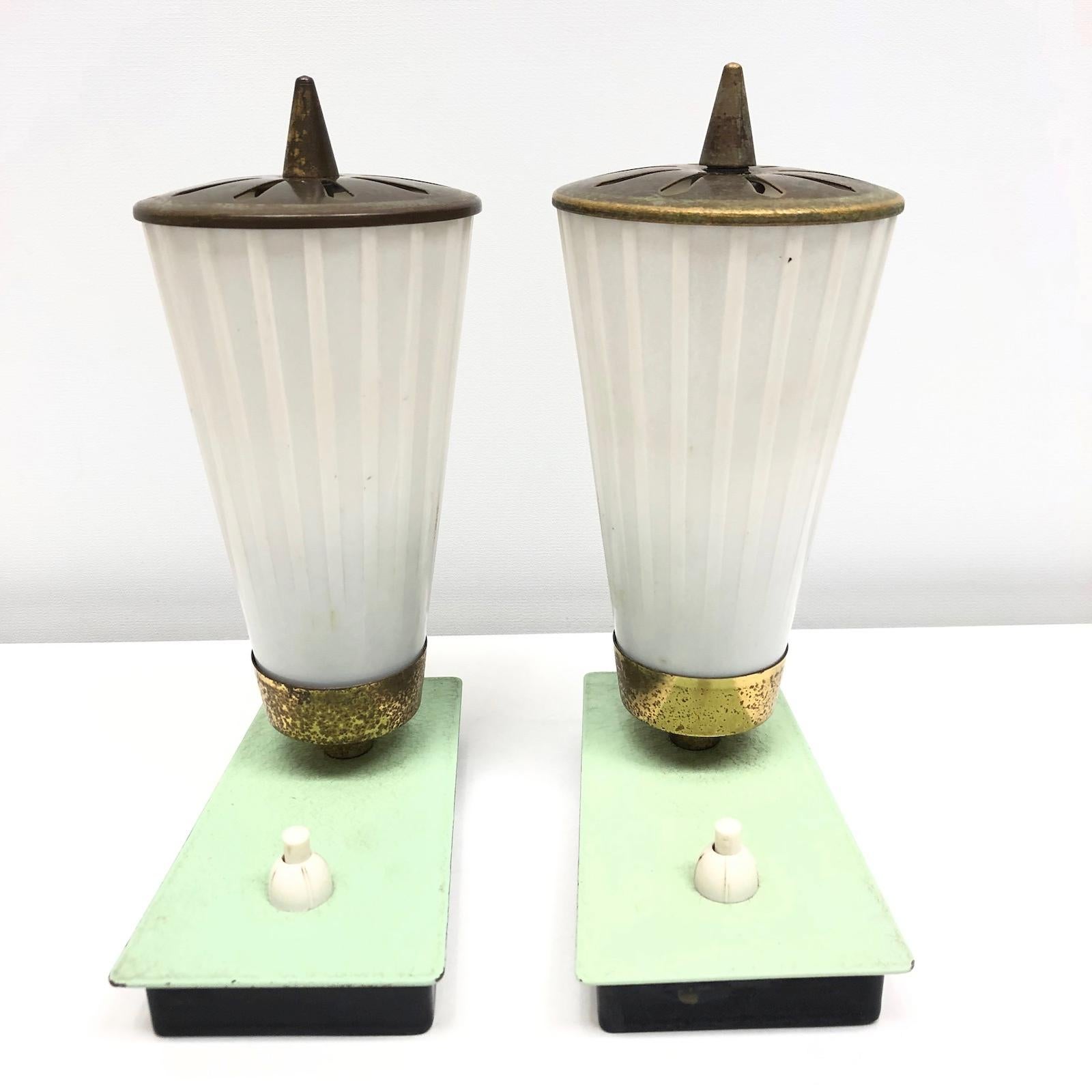 Petite pair of midcentury bedside, nightstands or table lamps. Each one requires one European E14 / 110 Volt Torpedo bulb, up to 60 watts. They can be wired to work in the USA, can get a US Plug if wanted. The brass is tarnished but this gives them