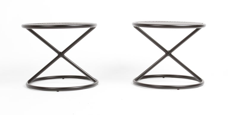Attributed Mathieu Matégot, these unique pair of patio or garden or side tables of French Mid-Century Modern period, have round perforated tops with tubular X supports on circular base. These came from a one owner, very swanky MCM home located in