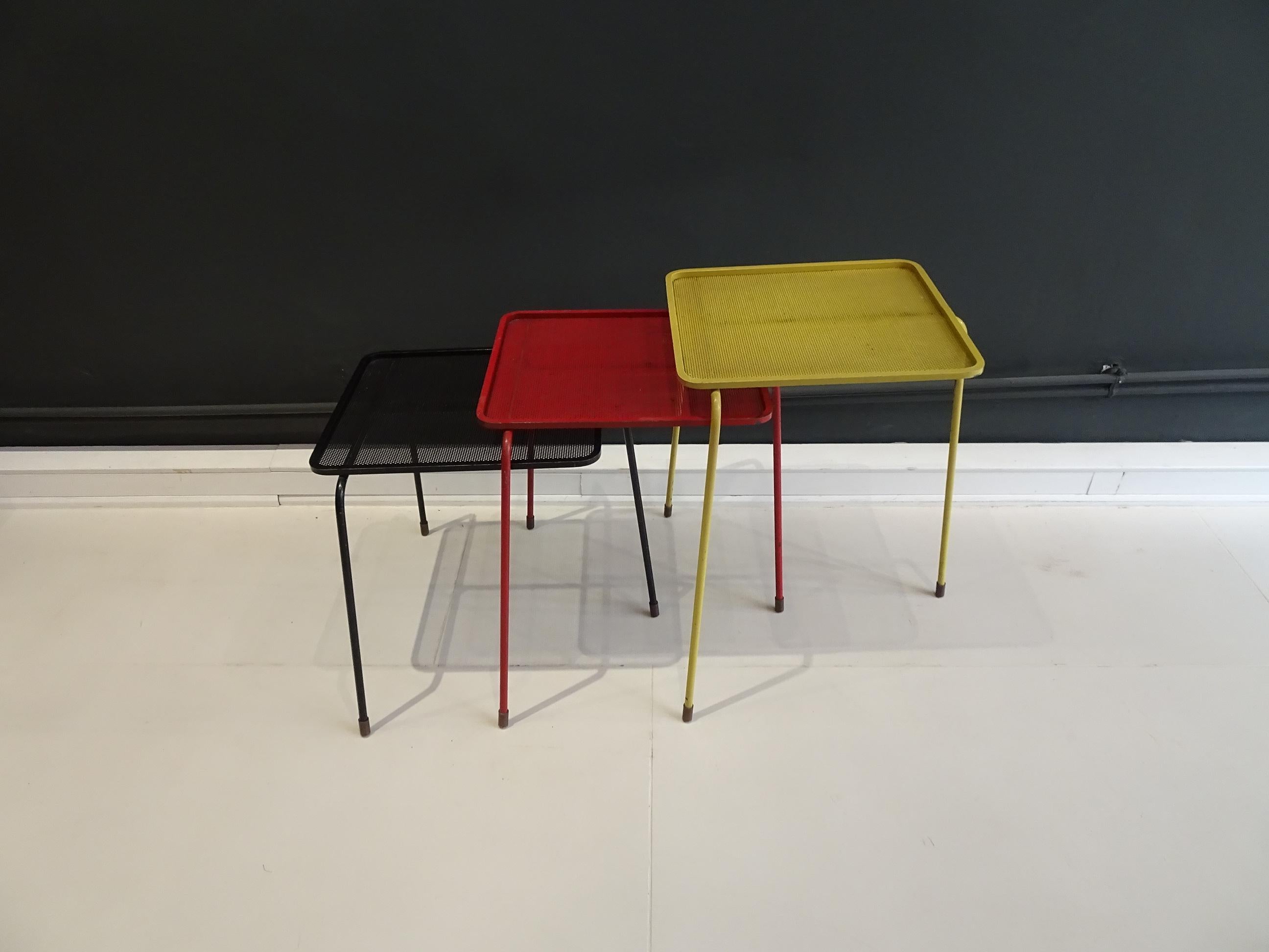 Set of three nesting tables model «Soumba». Perforated sheet lacquered yellow, red and black. 

France, e.g. 1953
Dimensions: 47.5 H x 33 W x 29 D cm.