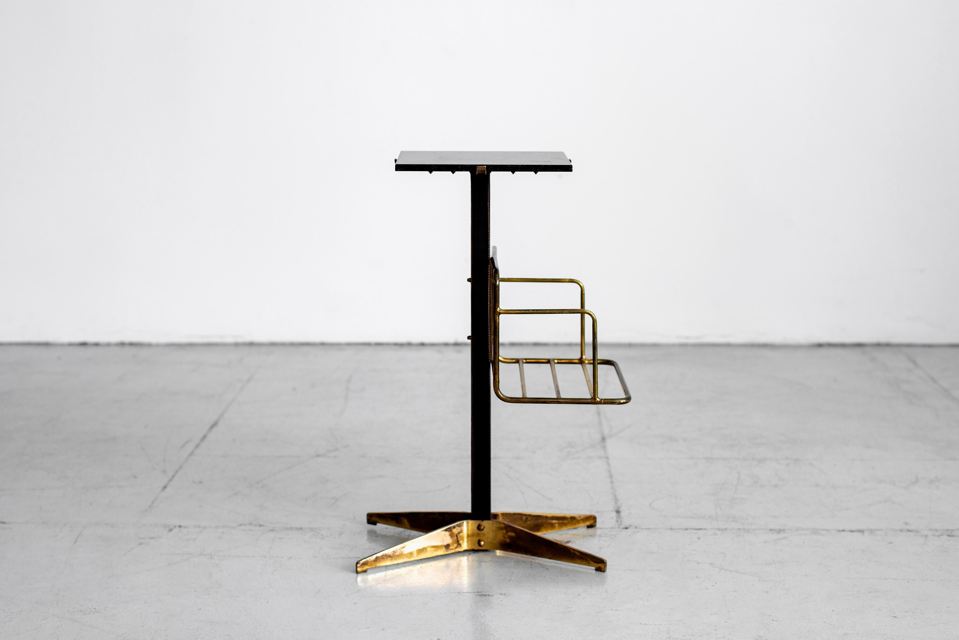 Handsome side table with black marble top, black leather stem with brass shelf and brass base by Mathieu Matégot. Great patina to brass.