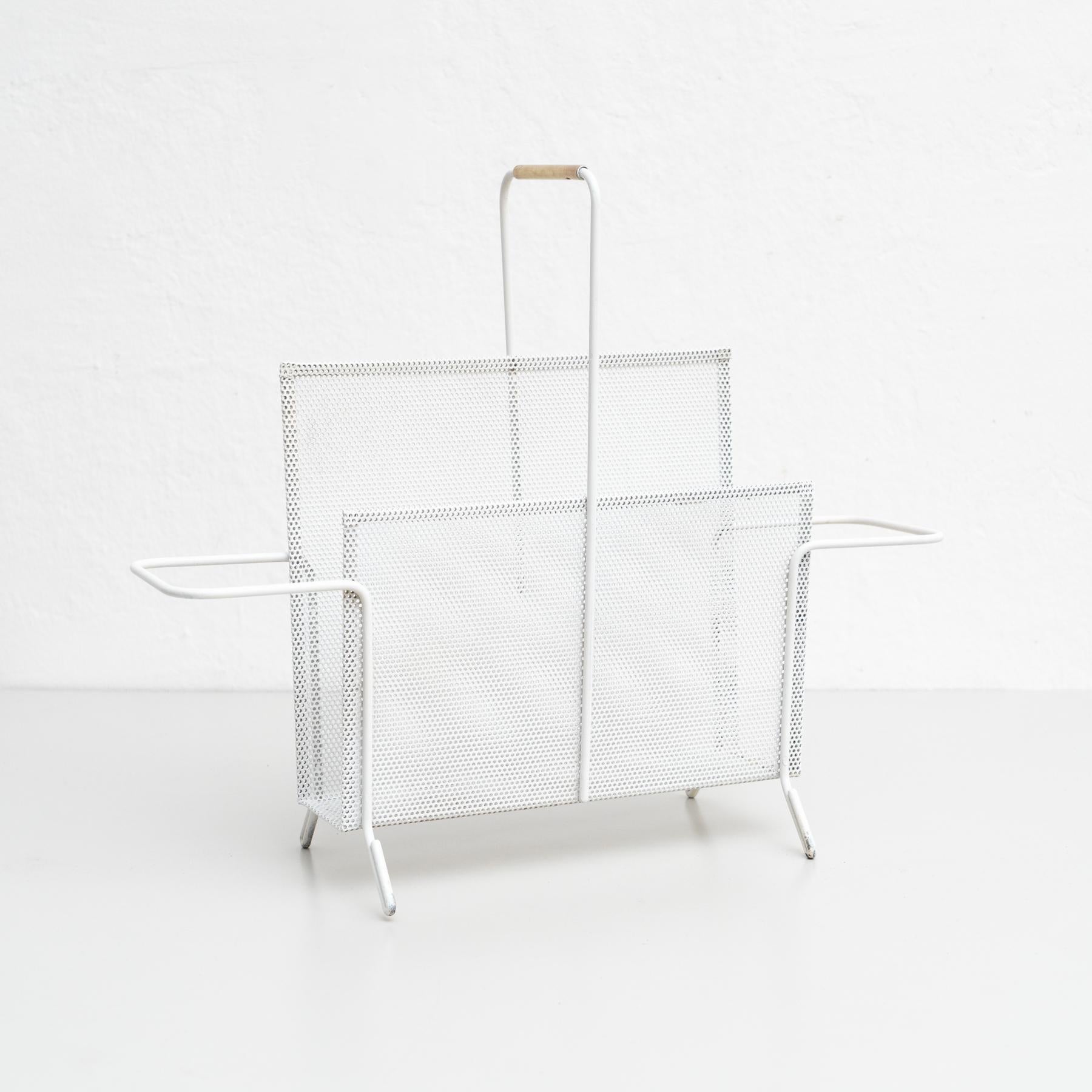 Magazine holder, designed by Mathieu Matégot.

Manufactured by ateliers Matégot (France), circa 1950.

Folded, perforated metal.

In good original condition, with minor wear consistent with age and use, preserving a beautiful patina. With some