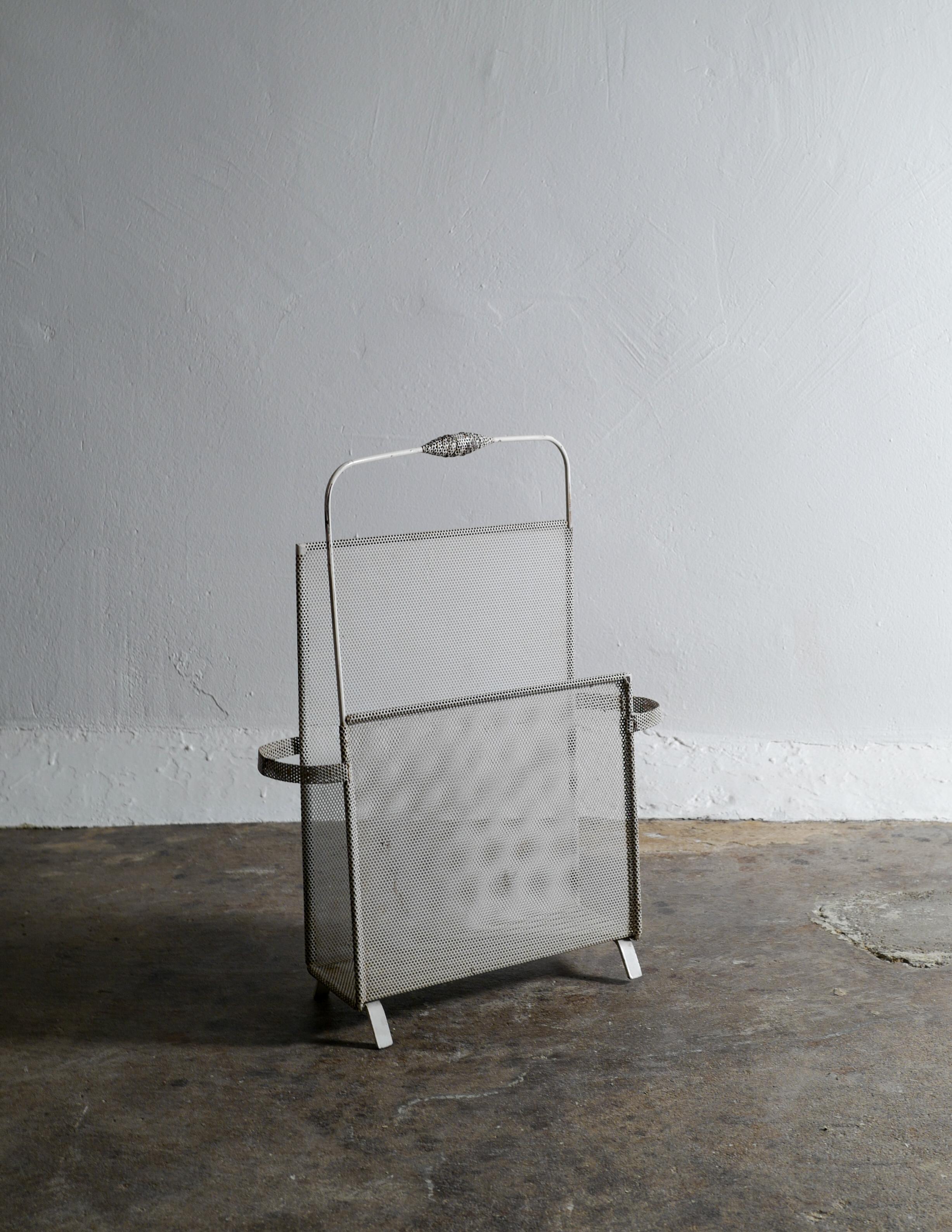 Rare magazine rack by Mathieu Matégot in white enameled metal. Original condition with strong and beautiful patina.