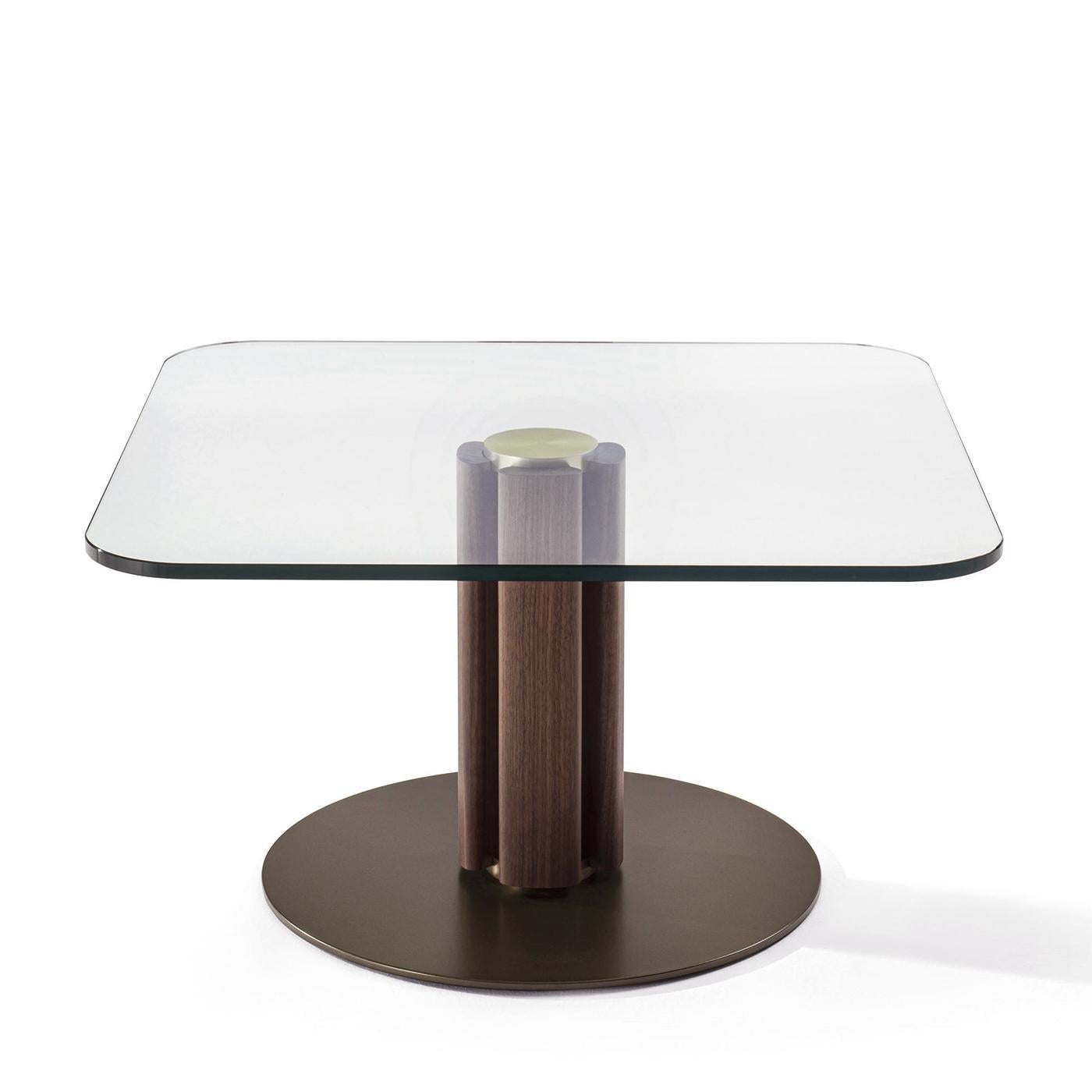 Side Table Mathilda with clear glass top, 15 mm thickness. 
With central pole made with solid walnut wood
with solid brass central pole in brushed finish.
With round metal base in bronze oro finish, 
round base diameter: 55cm.
L120xD120xH45cm,