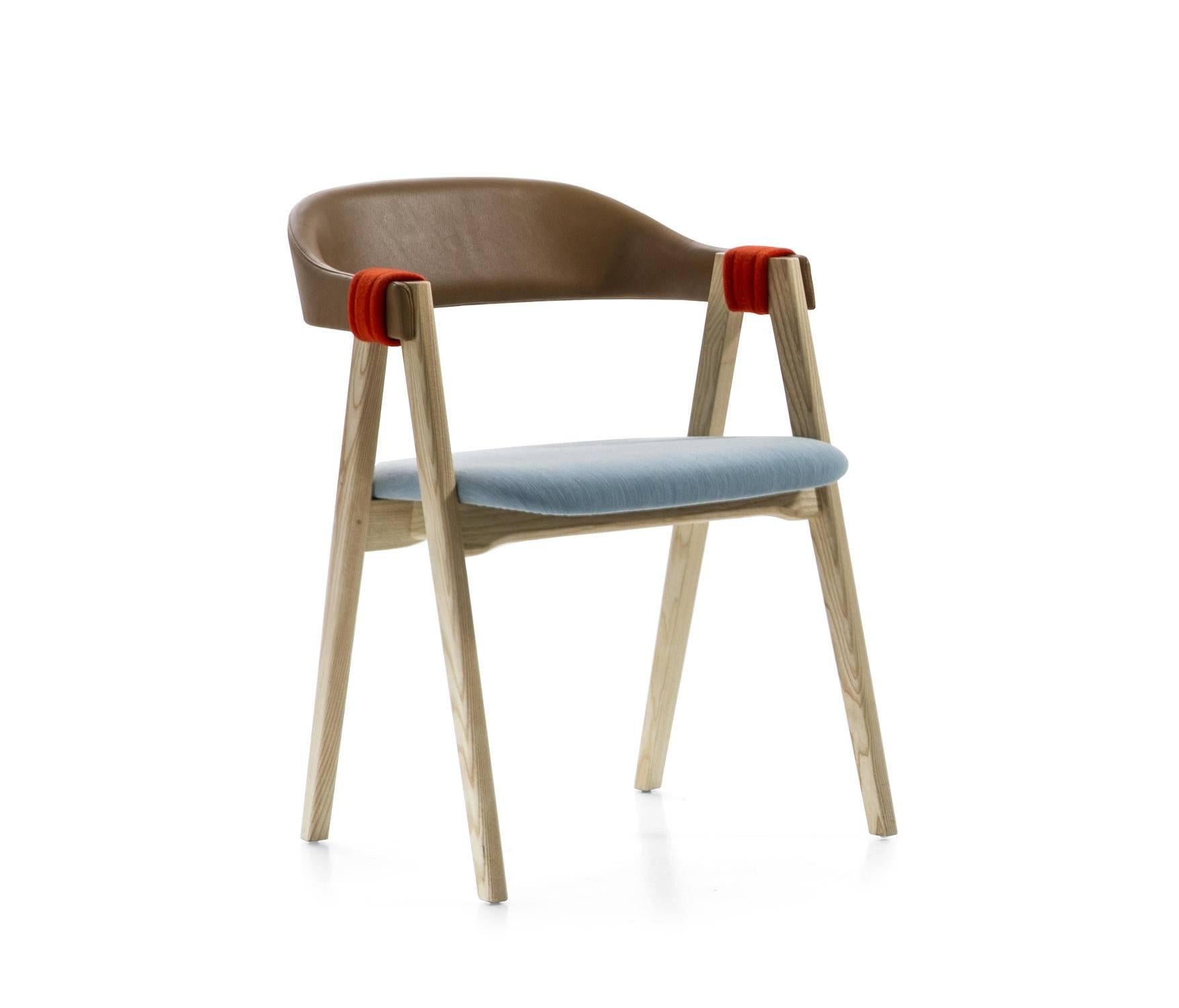 The Mathilda dining chair is produced with the seat and upholstered back in flame-retardant, stress-resistant polyurethane foam in varied densities on ash frame; raffiawrapped back is also available. Arm and leg connection is covered with fabric or