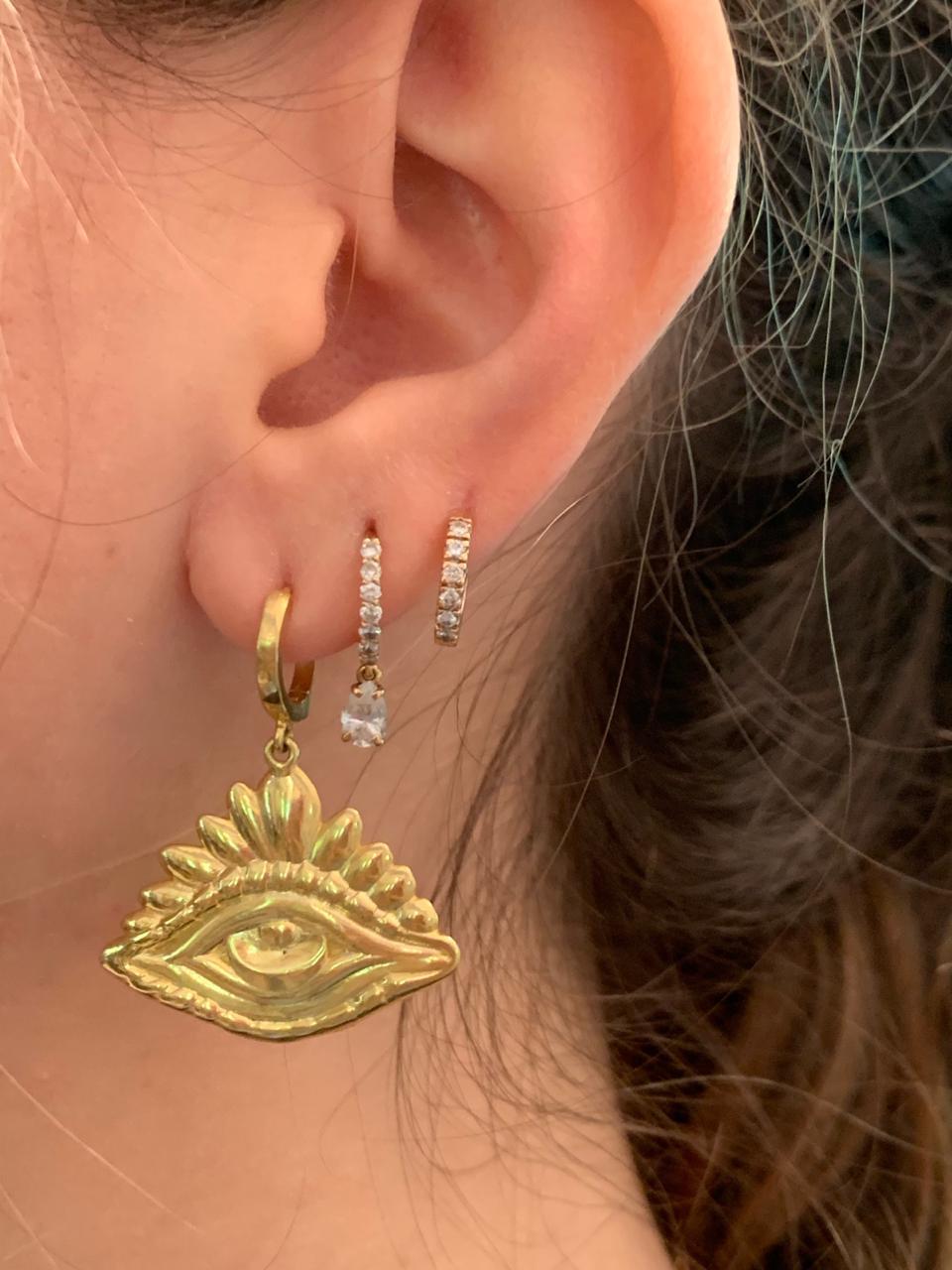 The Mati hoops are designed by Christina Alexiou.
This pair of hoop earrings is crafted with 18k yellow gold. As Christina Alexiou notes, she draws on jewellery's ancient purpose as 