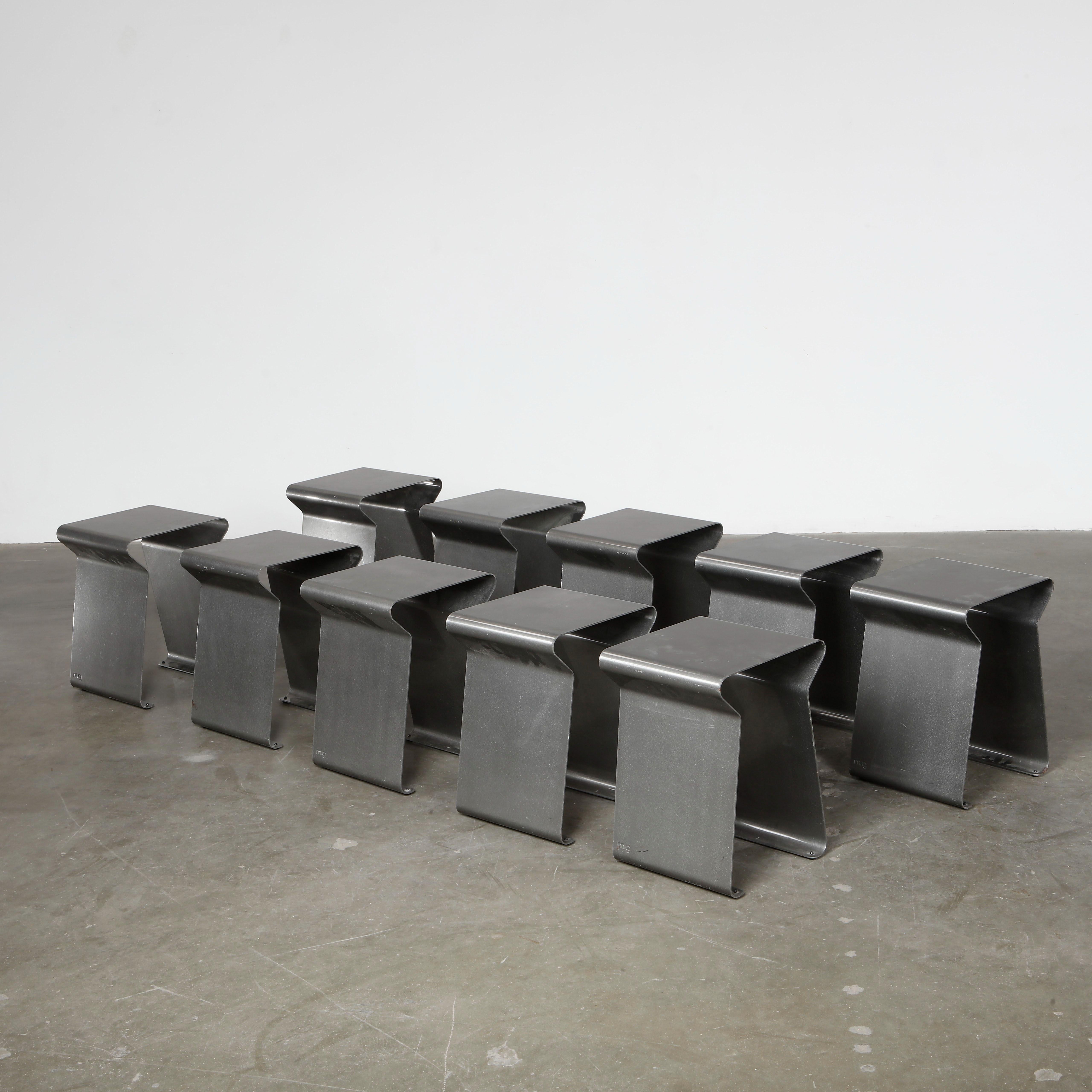 A complete set of sculptural brushed steel stools with playful U-shaped forms. French industrial chic with a contemporary edge. Height: 18 in. Width: 13 in. Depth: 12 in. 