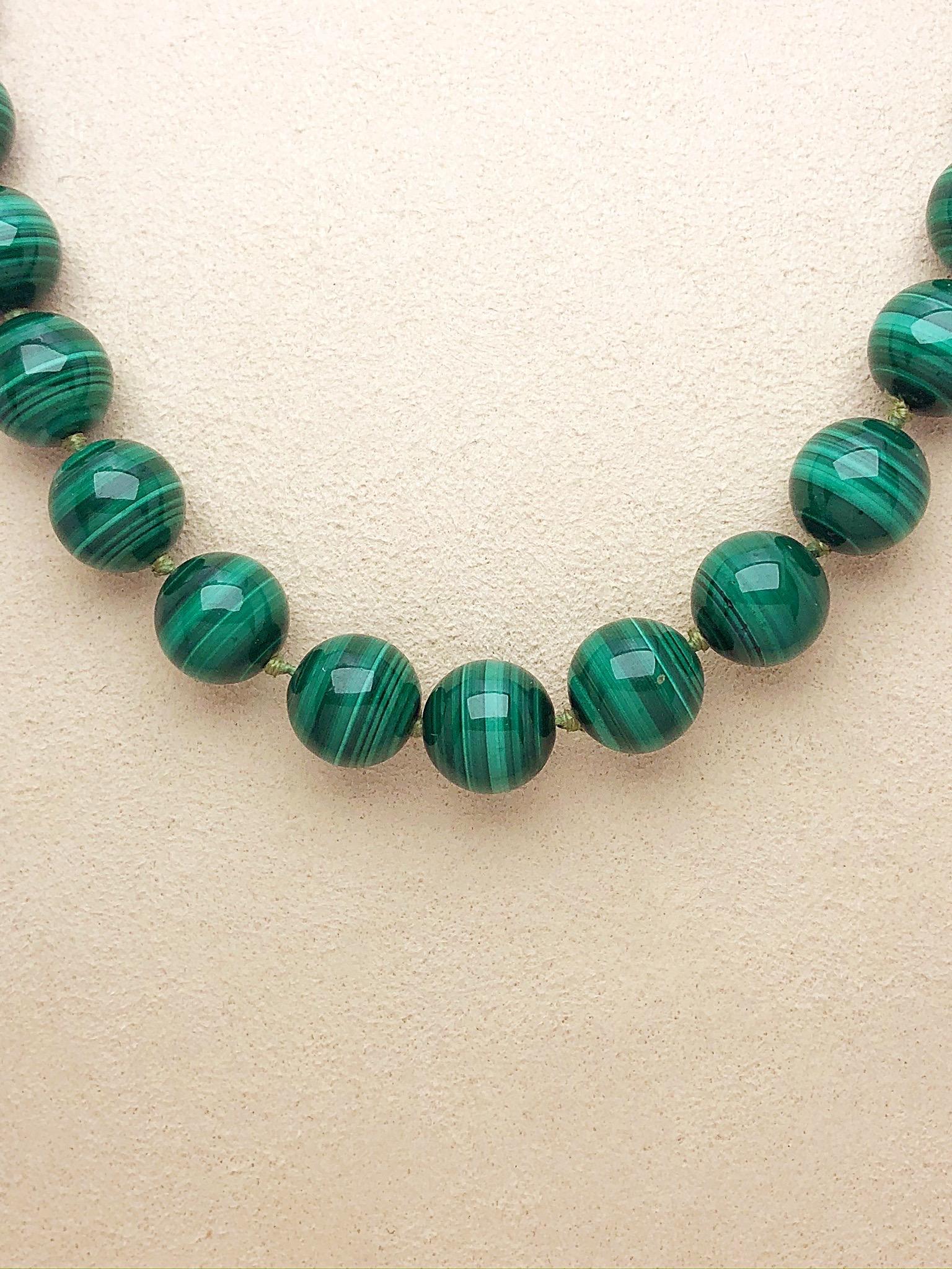Throw on this chic malachite beaded necklace for an updated casual, cool fashion statement. 
50 perfectly matched malachite beads, measuring 12mm each, are adorned by a showstopping oval 14kt yellow gold and malachite clasp. 
The necklace measures