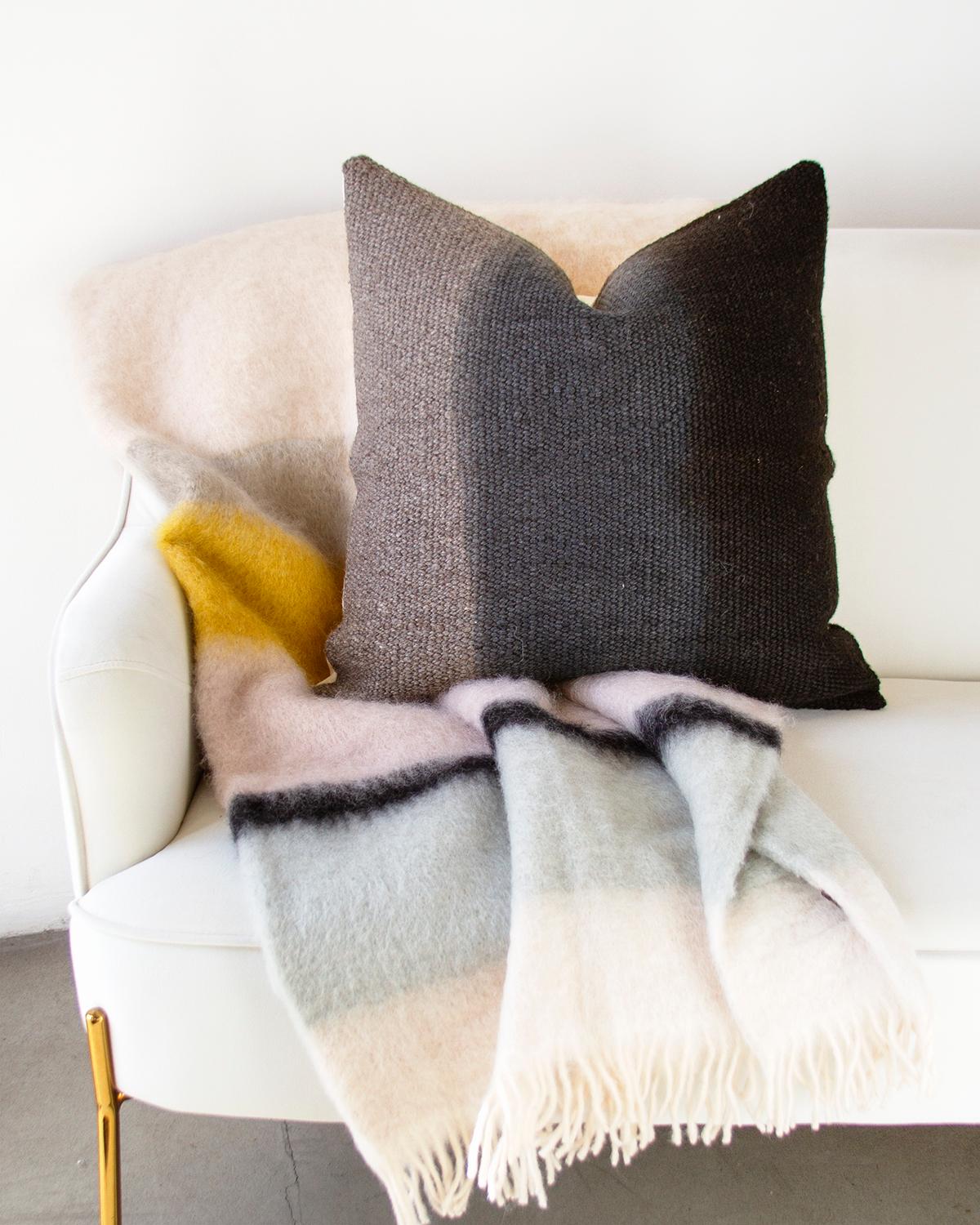 This Matiz Gray Ombre Throw Pillow provides a unique way to add organic modern style to your home décor. Hand-woven from sheep wool, the ombre effect is achieved with plant dyes that give it a rustic look. This square-shaped pillow is perfect as an