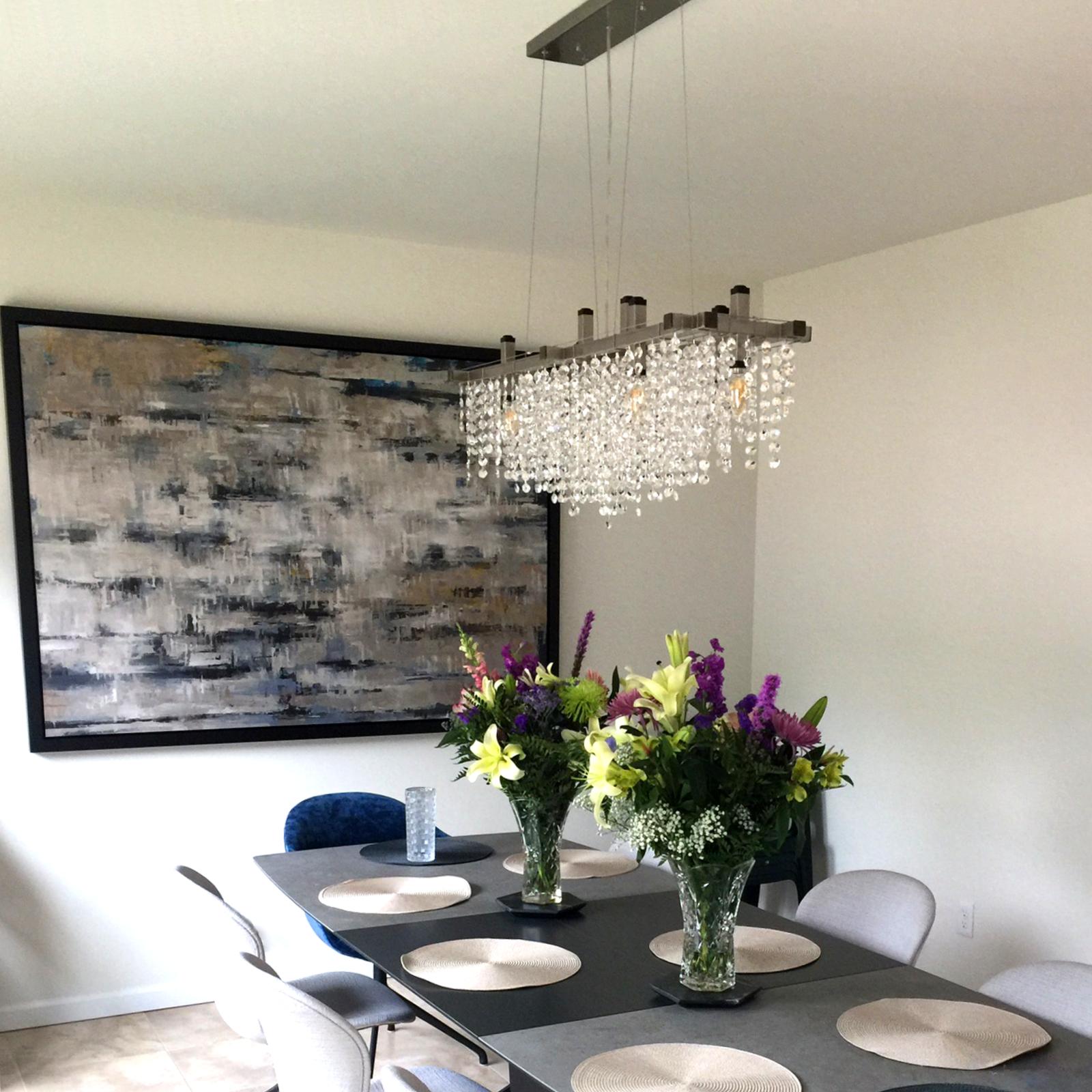 The matrix crystal linear suspension chandelier is a figurative shower of light, refraction, and highly-polished crystal. Random chains of high-quality crystal octagons and squares hang from a taut steel cable grid to create the appearance of