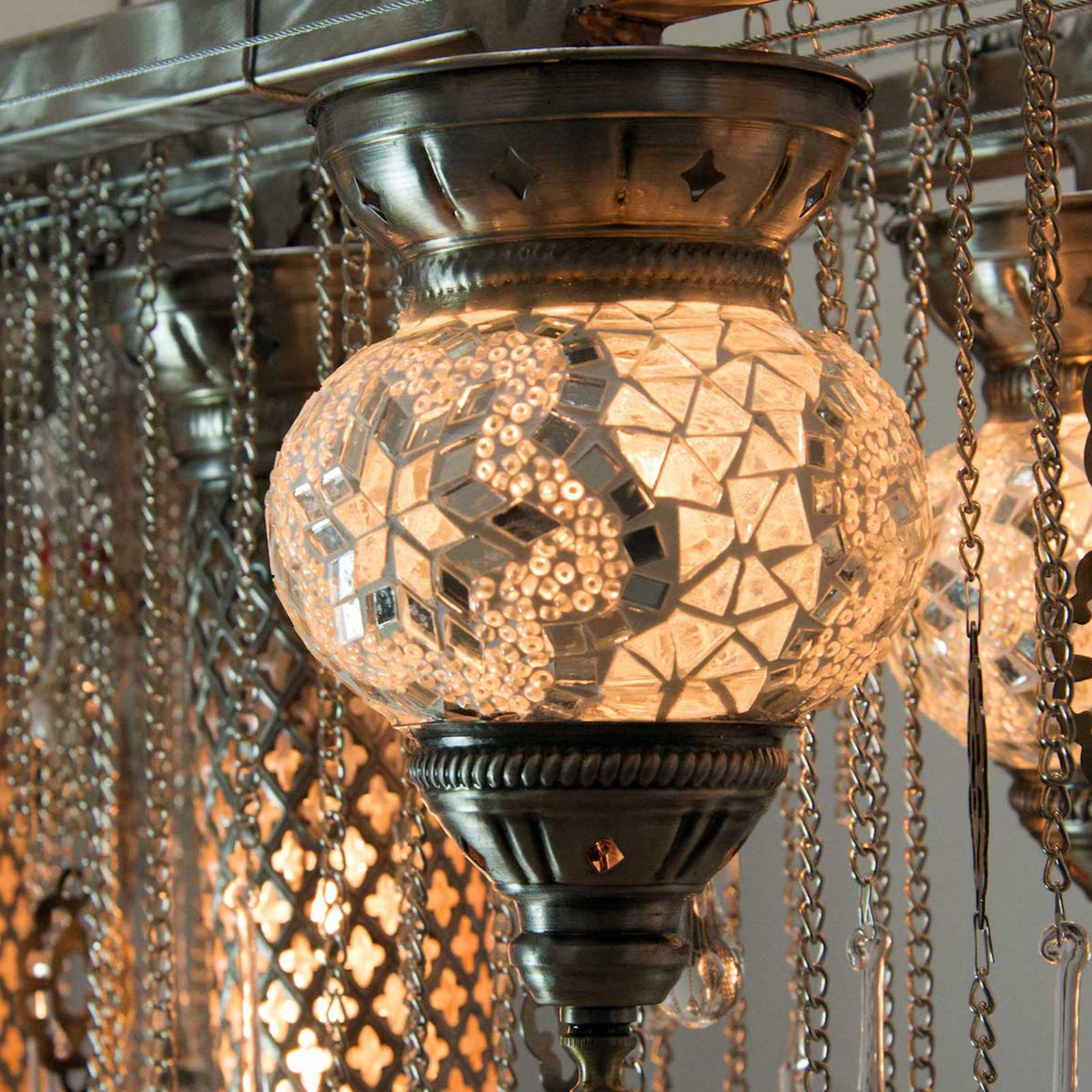 Transport your interior space to the Grand Bazaar with the Matrix Istanbul linear suspension chandelier. This highly-detailed modern chandelier features genuine ottoman hand blown glass and metal lanterns, chains, and drop crystals. The hand blown