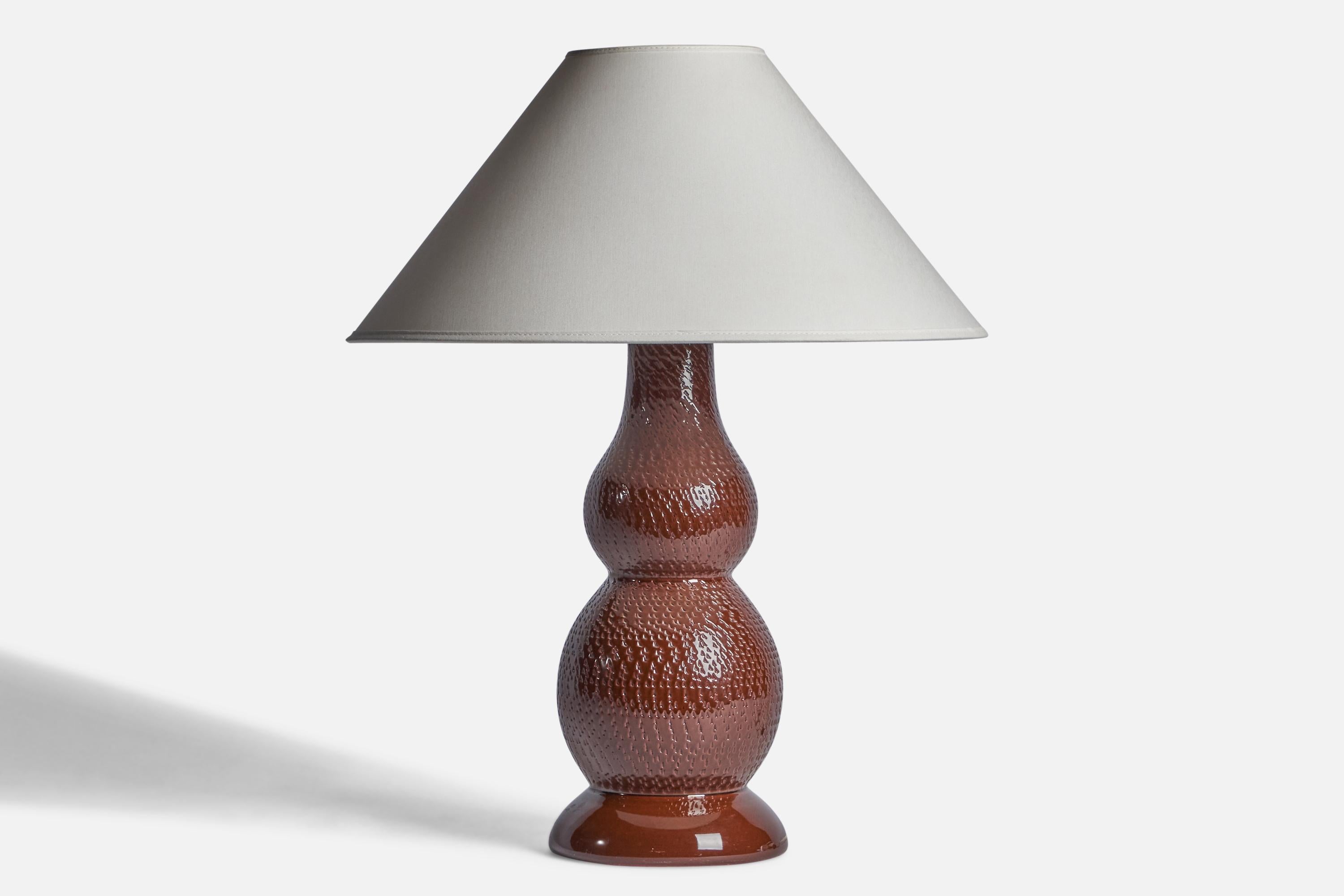A brown-glazed incised stoneware table lamp designed by Mats Birgersson and produced by Töreboda Keramik, Sweden, c. 1960s.

Dimensions of Lamp (inches): 15.75” H x 5.75” Diameter
Dimensions of Shade (inches): 4.5” Top Diameter x 16” Bottom Diameter