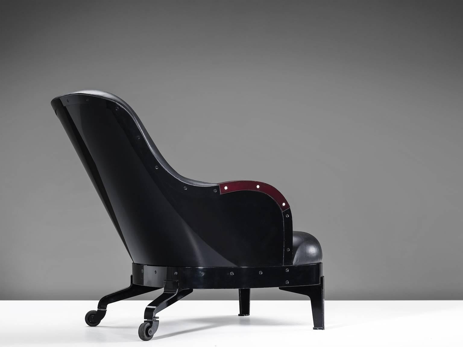 The Ritz lounge chair, in steel, wood, elk horn and leather by Mats Theselius for Källemo, Sweden, 1994.
 
This limited edition lounge chair with caster wheels is executed in black enamel steel, black leather upholstery and elk Horn inlay on the