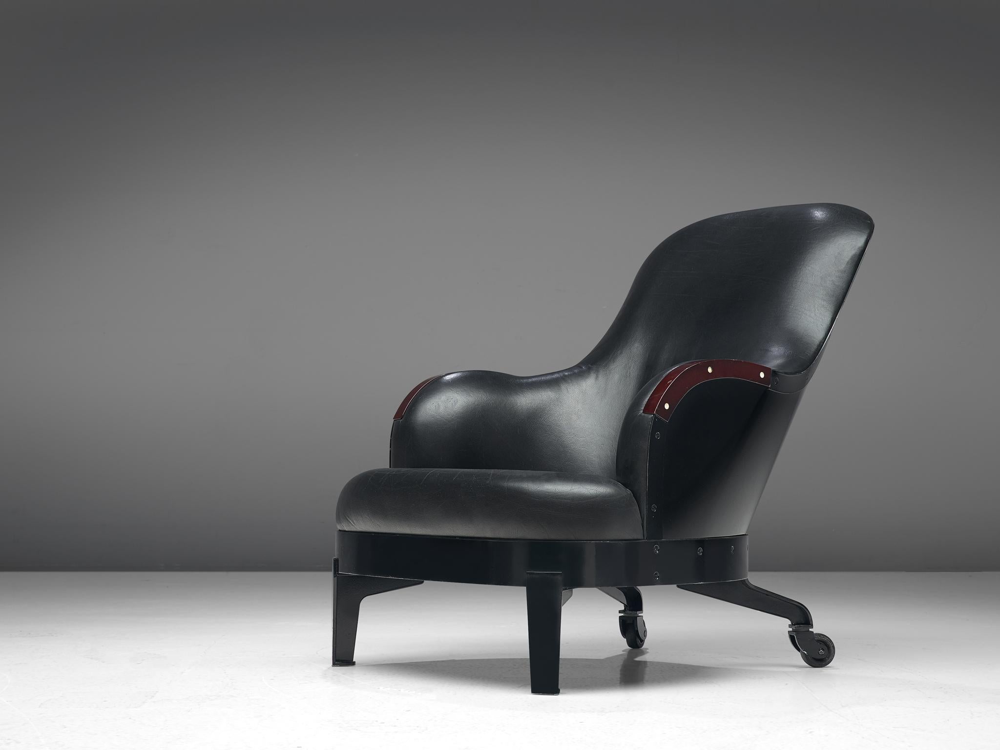 The Ritz lounge chair, in steel, wood, elk horn and leather by Mats Theselius for Källemo, Sweden, 1994.
 
This limited edition lounge chair with caster wheels is executed in black enamel steel, black leather upholstery and elk Horn inlay on the