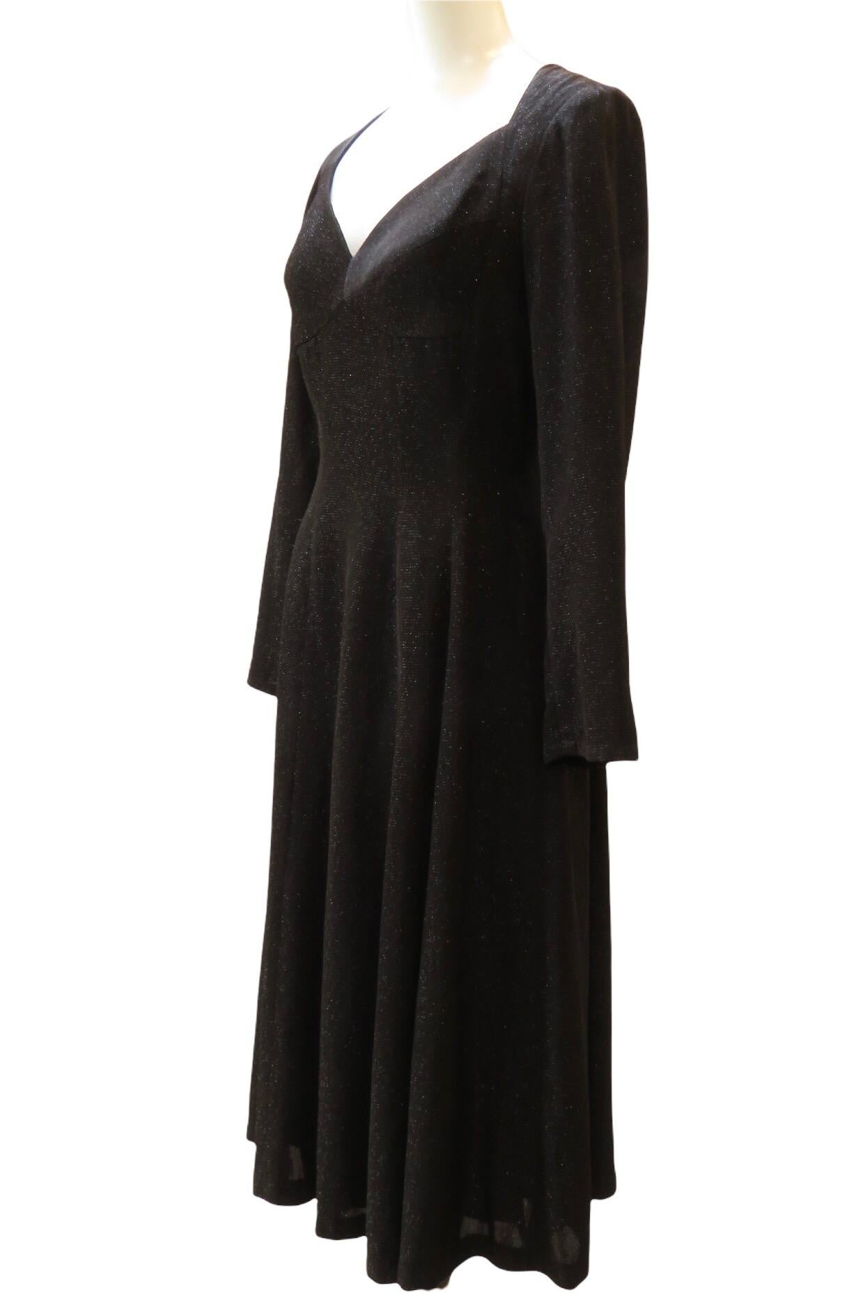 A shimmering black knee length, Lon sleeved dress by Matsuda Nicole features a flattering sweetheart neckline and back zipper.