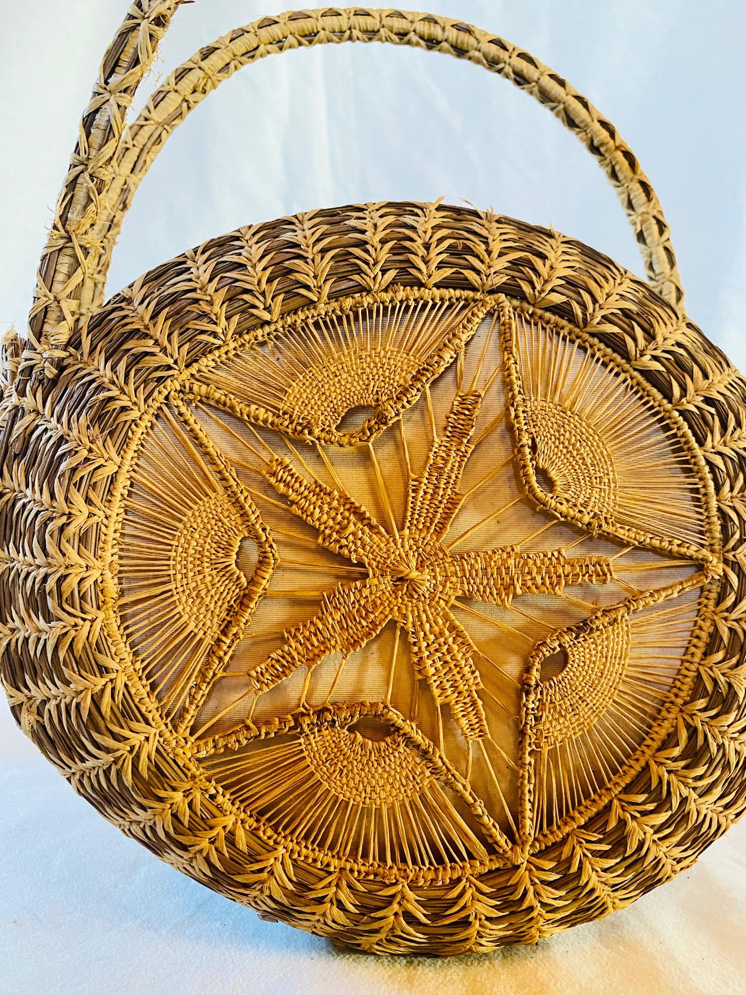 Early Vintage Mattapoisett Basket, by Gladys Ellis, Mid 20th Century, a hand-crafted basket modeled after a Nantucket purse, having a round disk shape with open top, made of hand-stitched longleaf pine needles and raffia in braided and lace-like