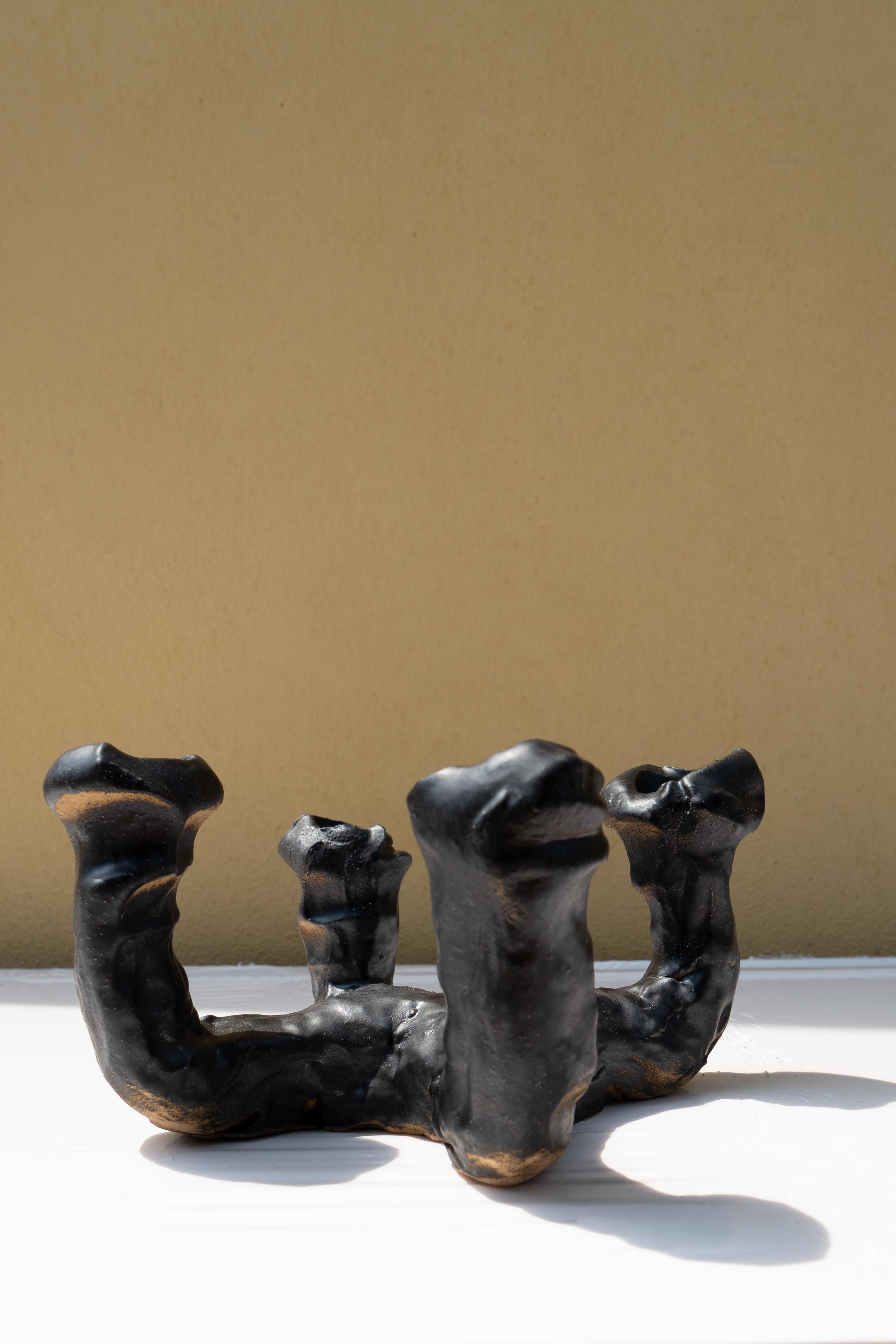 Matte black candelabra by Daniele Giannetti
Dimensions: Ø 29 x H 14 cm.
Materials: Glazed terracotta. 
This candelabra can hold four candles. Also available for three candles.

All pieces are made in terracotta from Montelupo, only fired once,