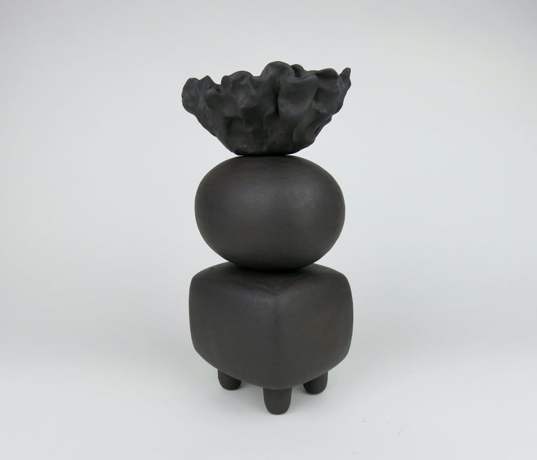 One in a new series of modern TOTEMS consisting of soft round or rectangular forms on small conical feet. The shapes begin as a solid piece. They are then hollowed out, stacked and in this case, coated in a brown/black clay slip. The top of this one