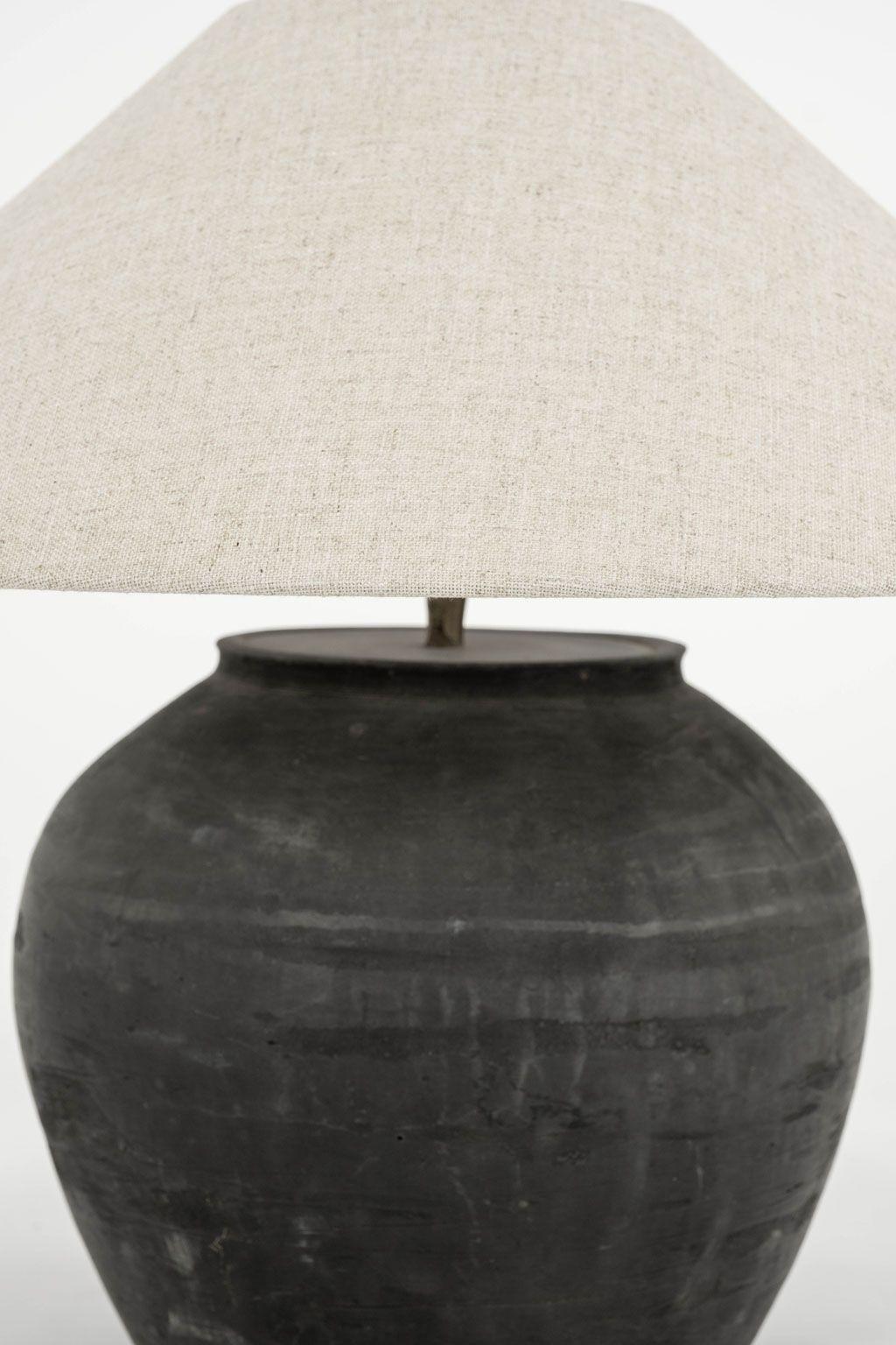 Matte black unglazed lamp with natural-color linen coolie shade (listed measurements include shade). Hand-made ceramic jar, newly wired (for use within the USA) as table lamp. Two available and sold individually, priced $2,600 each.

Measures 17.5