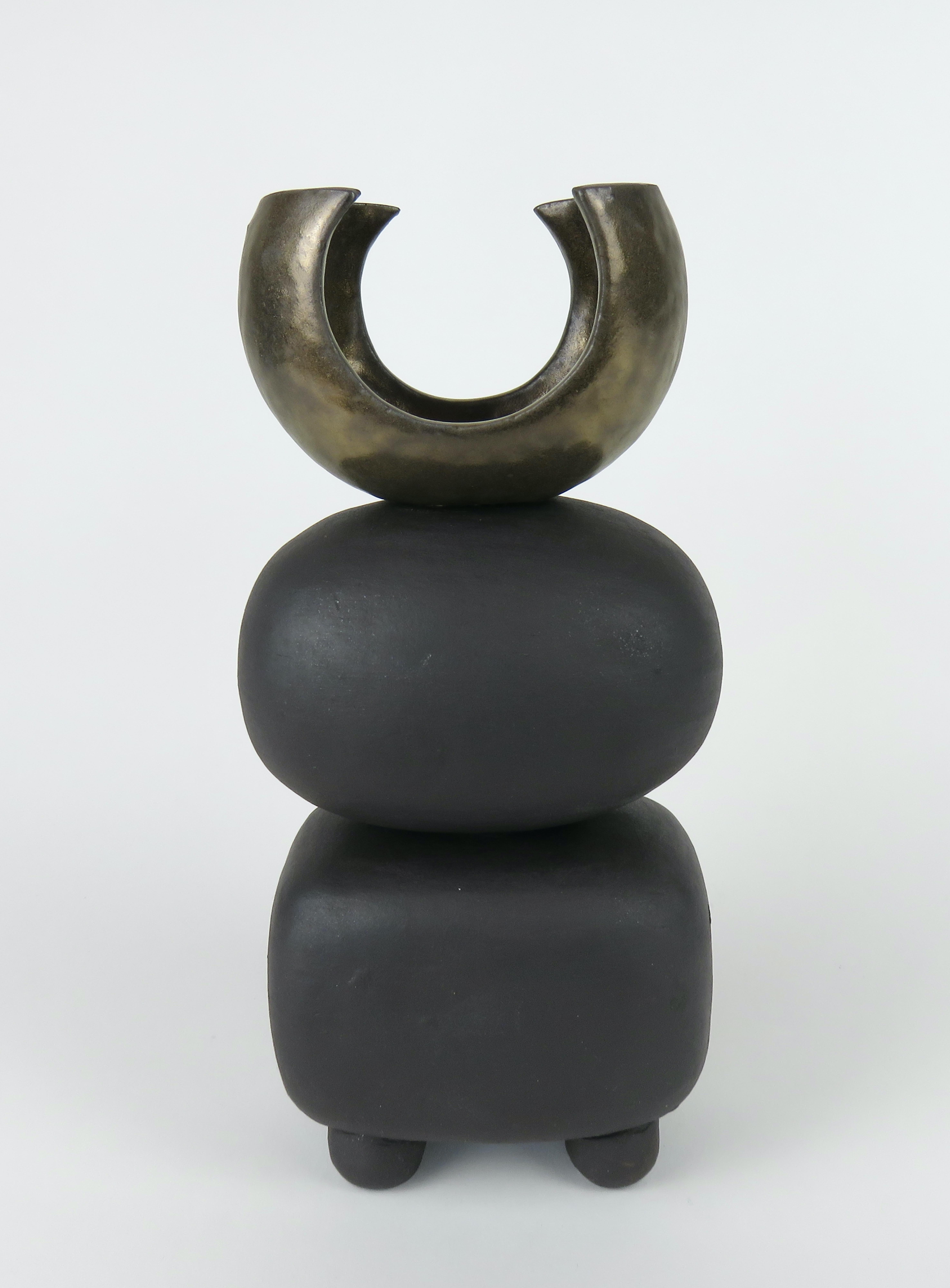 One in a new series of Modern TOTEMS consisting of soft round or rectangular forms on small conical feet. The shapes begin as a solid piece. They are then hollowed out, stacked and the feet attached. The top of this one is a large curved shape, like