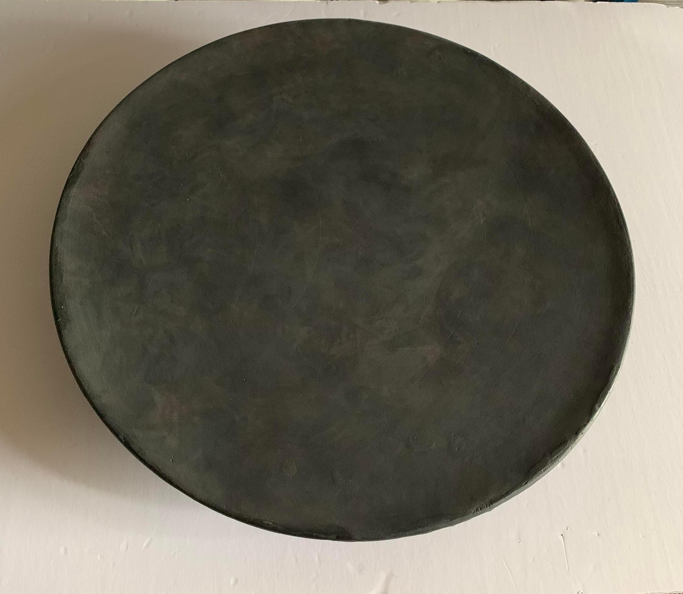 Contemporary Danish design large round platter.
Sits on three legs.
Matte dark grey glaze.
One of a collection of many shapes and sizes.