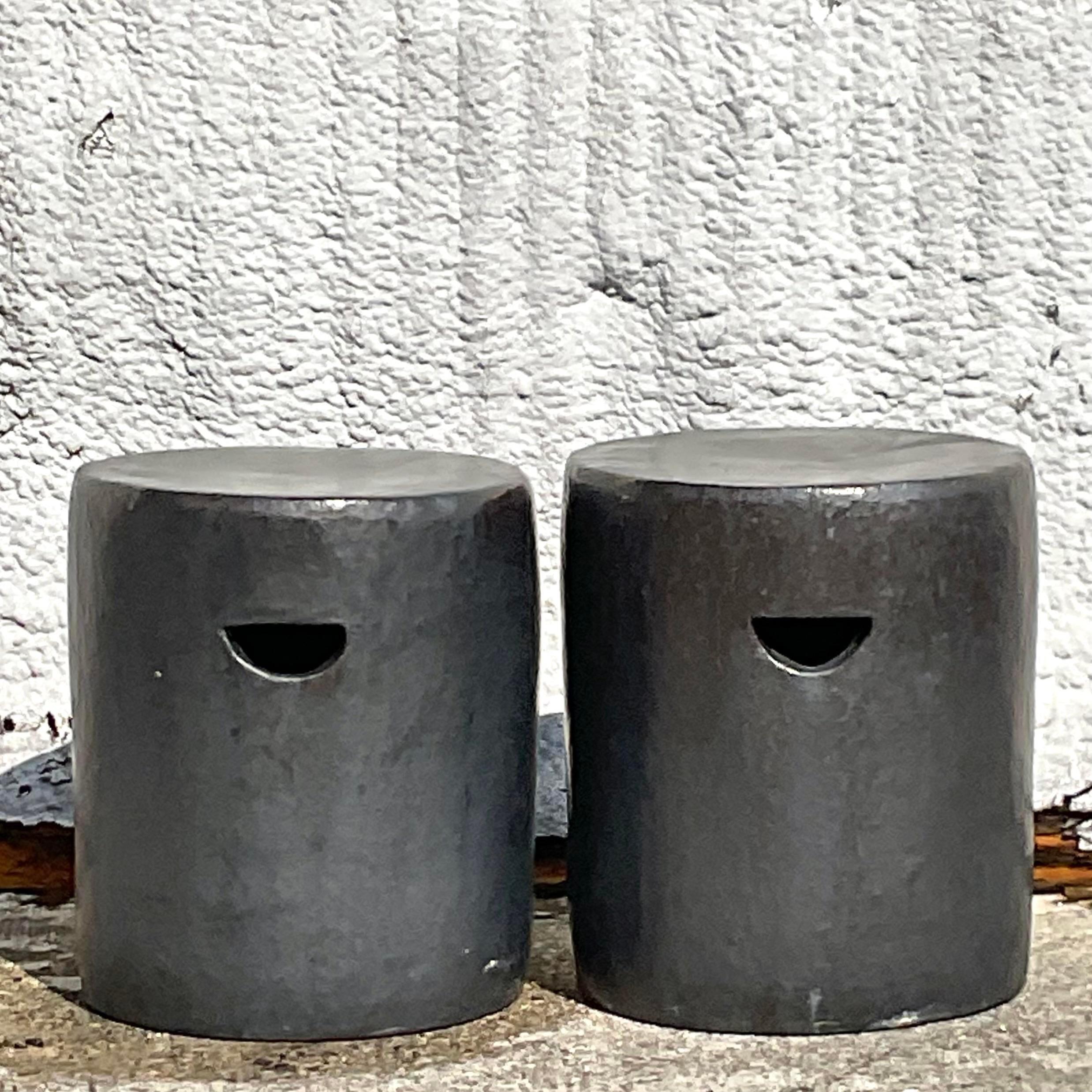 A fabulous pair of Boho low garden stools. A chic matte glazed heavy ceramic with chic and simple half moon cutouts. A beautiful grey color. Acquired from a Palm Beach estate.

One stool is slightly lower than the other by 3/4 of an inch. But it
