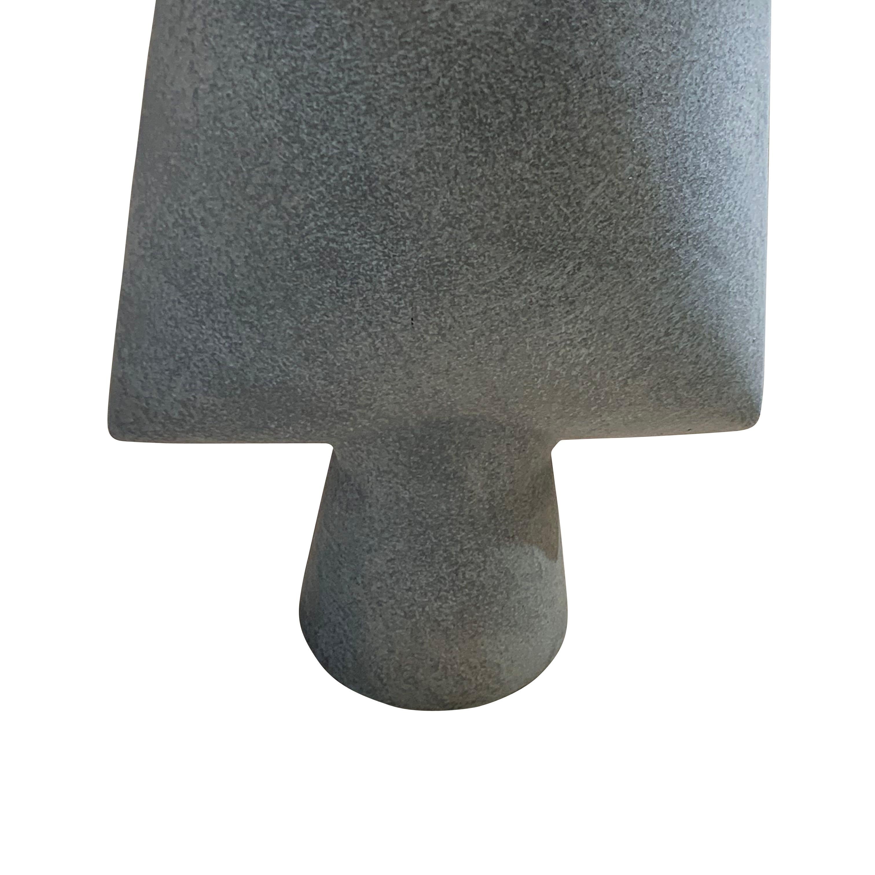 Contemporary Danish design small square shaped vase on cylinder base
Matte grey glaze.
One of a collection of many shapes and sizes.
ARRIVAL TBD
 