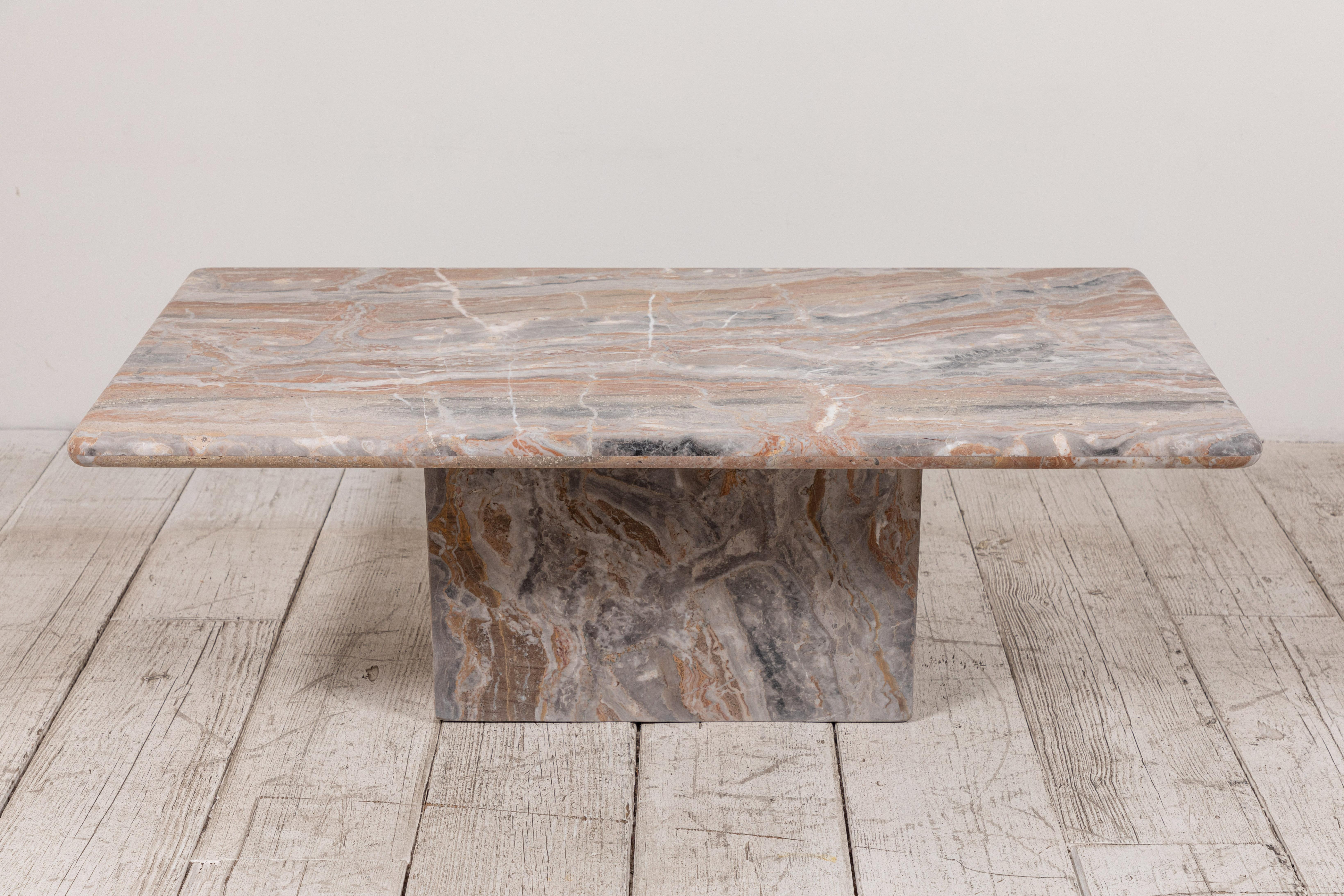 Honed marble rectangular coffee table offers beautiful markings and softened edges.
