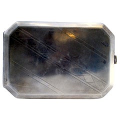 Matte silver case with oblique geometric engravings and hinged lid