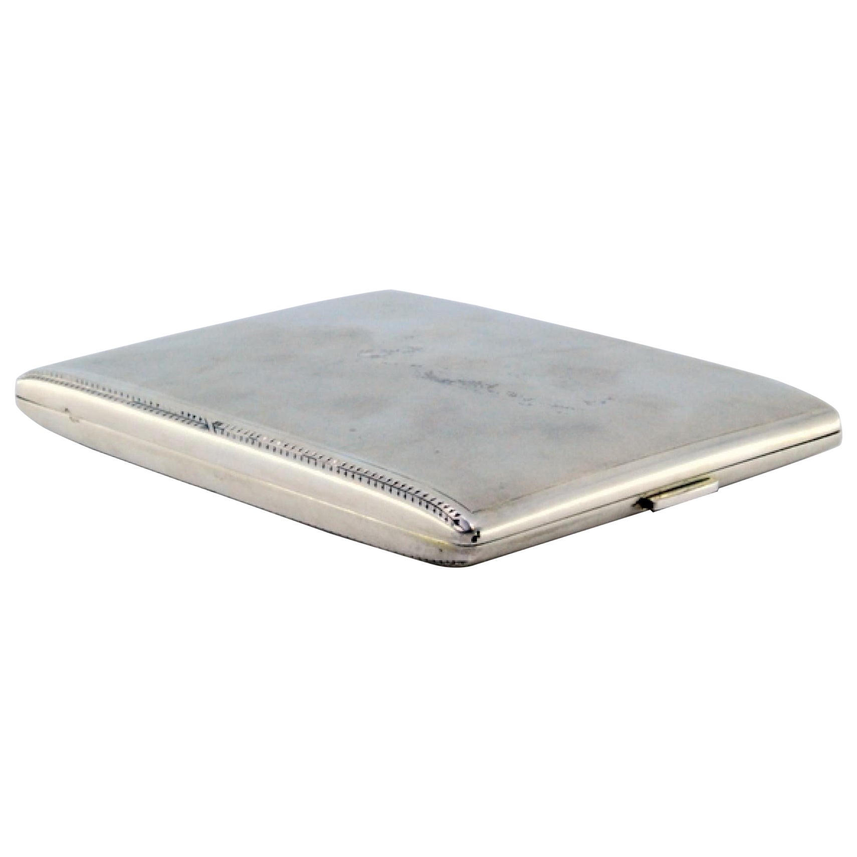 Matte silver cigarette case w/ borders on the edge, gold interior 
hinged lid