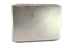 Matte silver cigarette case w/ raised strips along the length & gold interior